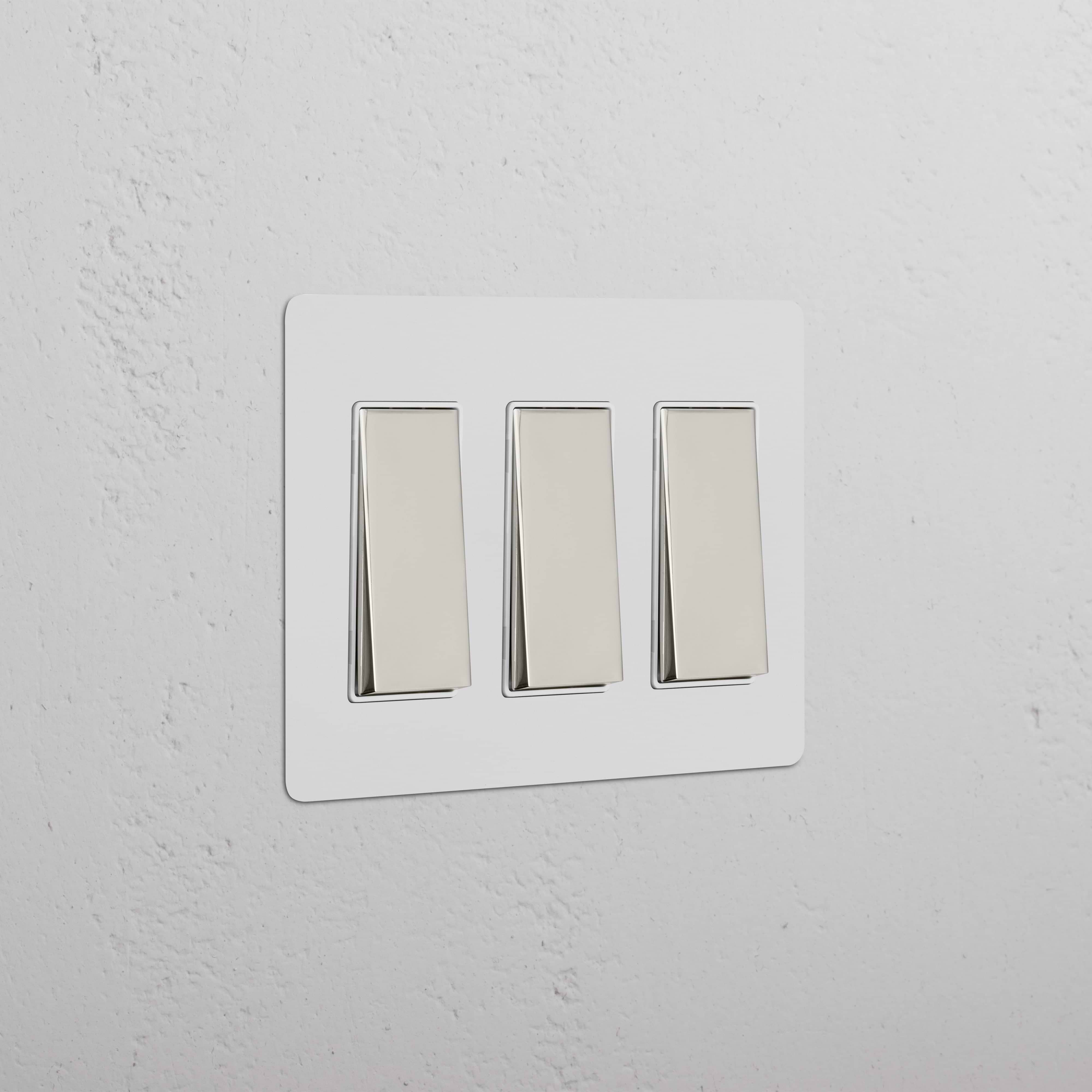 Kew 3G Rocker Switch in paintable polished nickel white finish with three rectangular rocker switches.