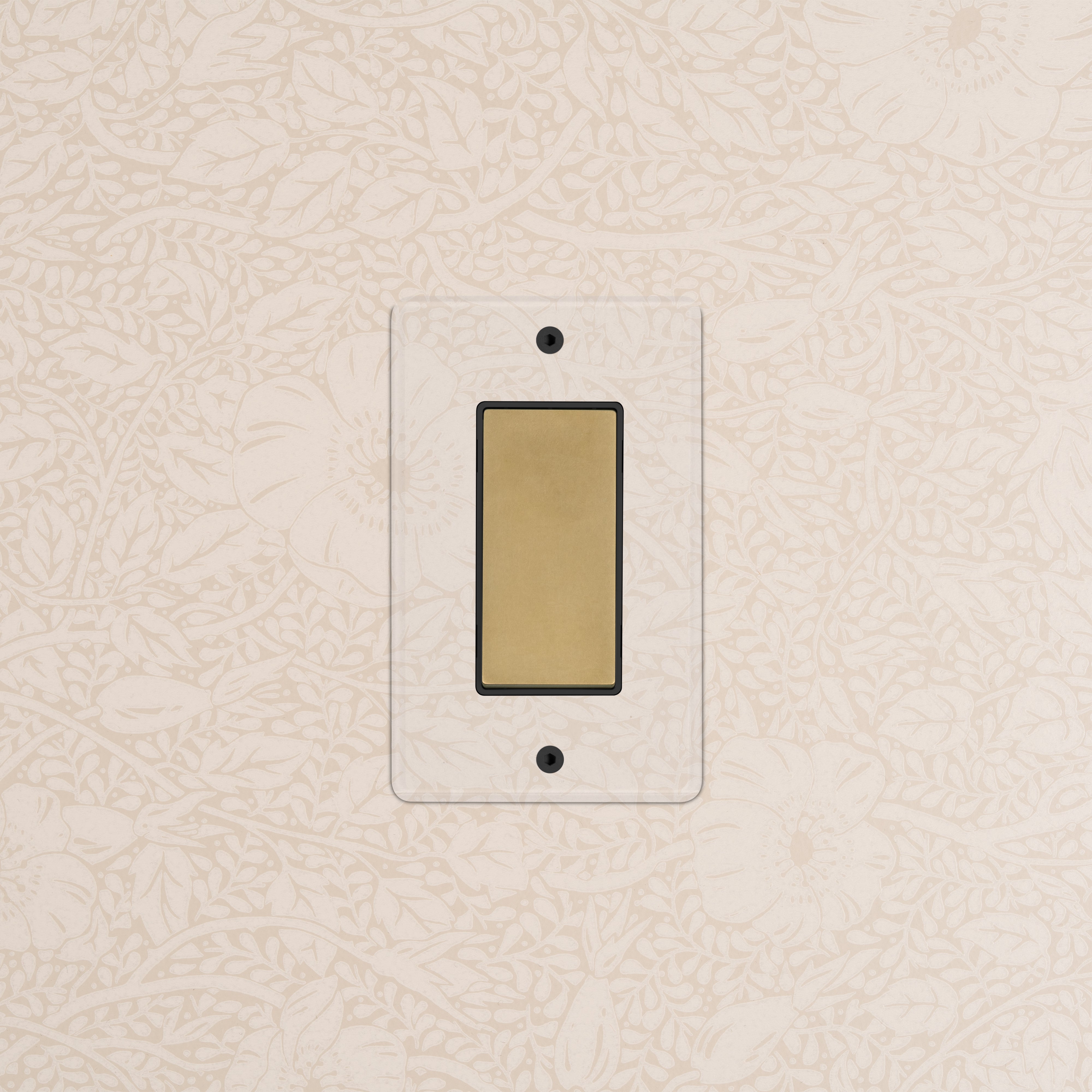 Kew 1G Dimming Retractive Rocker Switch in clear antique brass black, mounted on a floral wallpapered wall.