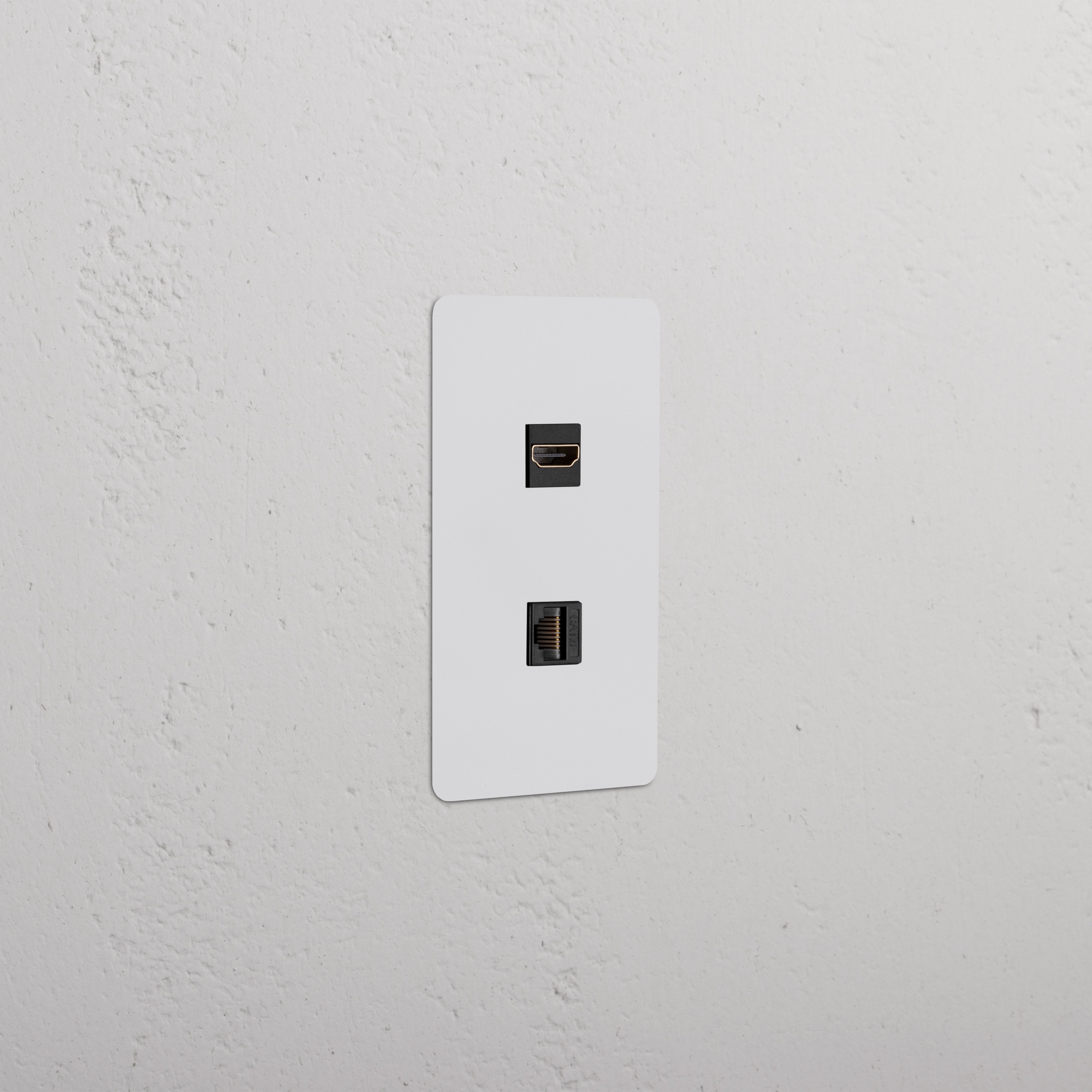 Kew 1G HDMI & CAT 6 Keystone, paintable black faceplate with two ports, installed on a wall.
