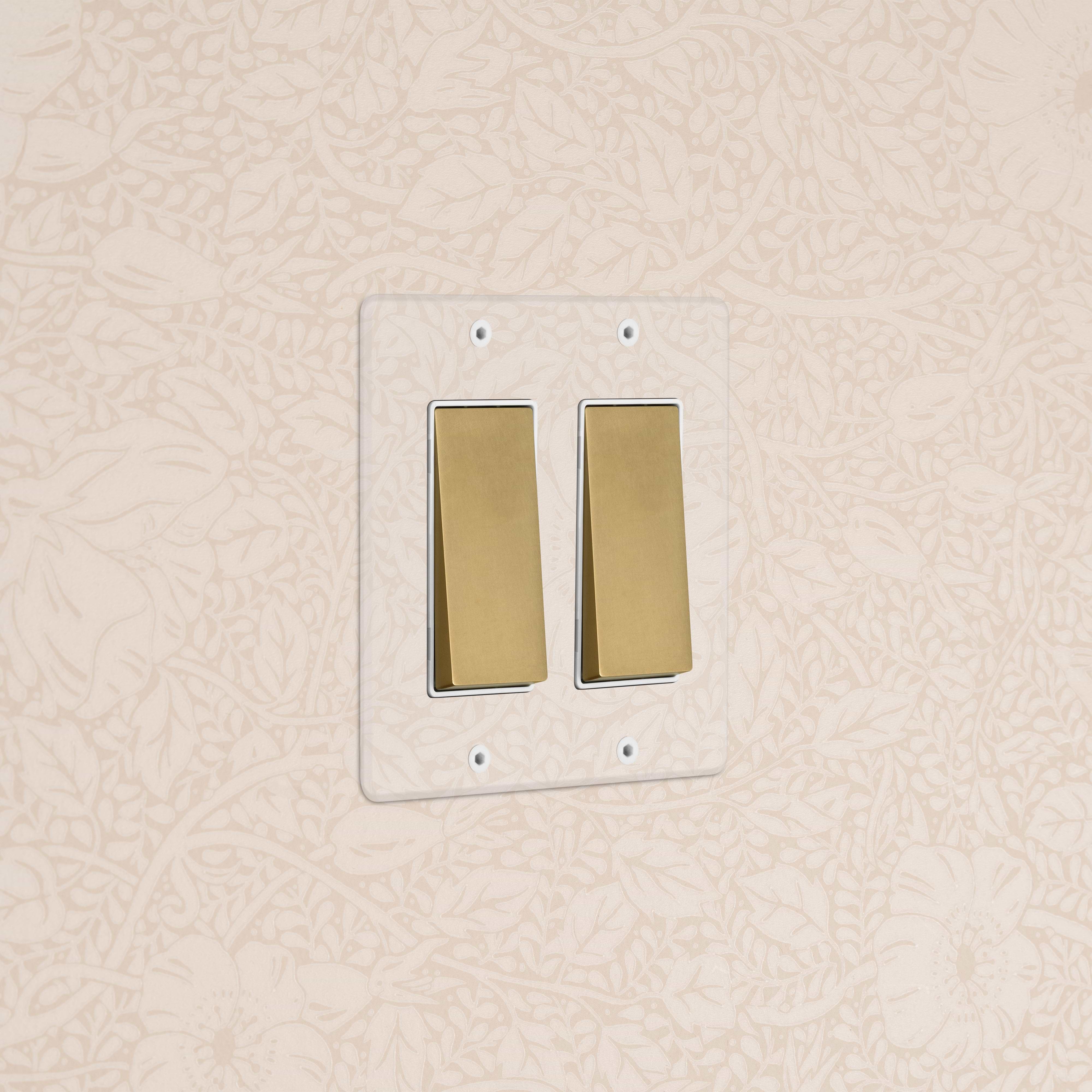 Kew 2G Rocker Switch in Clear Antique Brass White finish, double rocker on white plate, wall mounted.