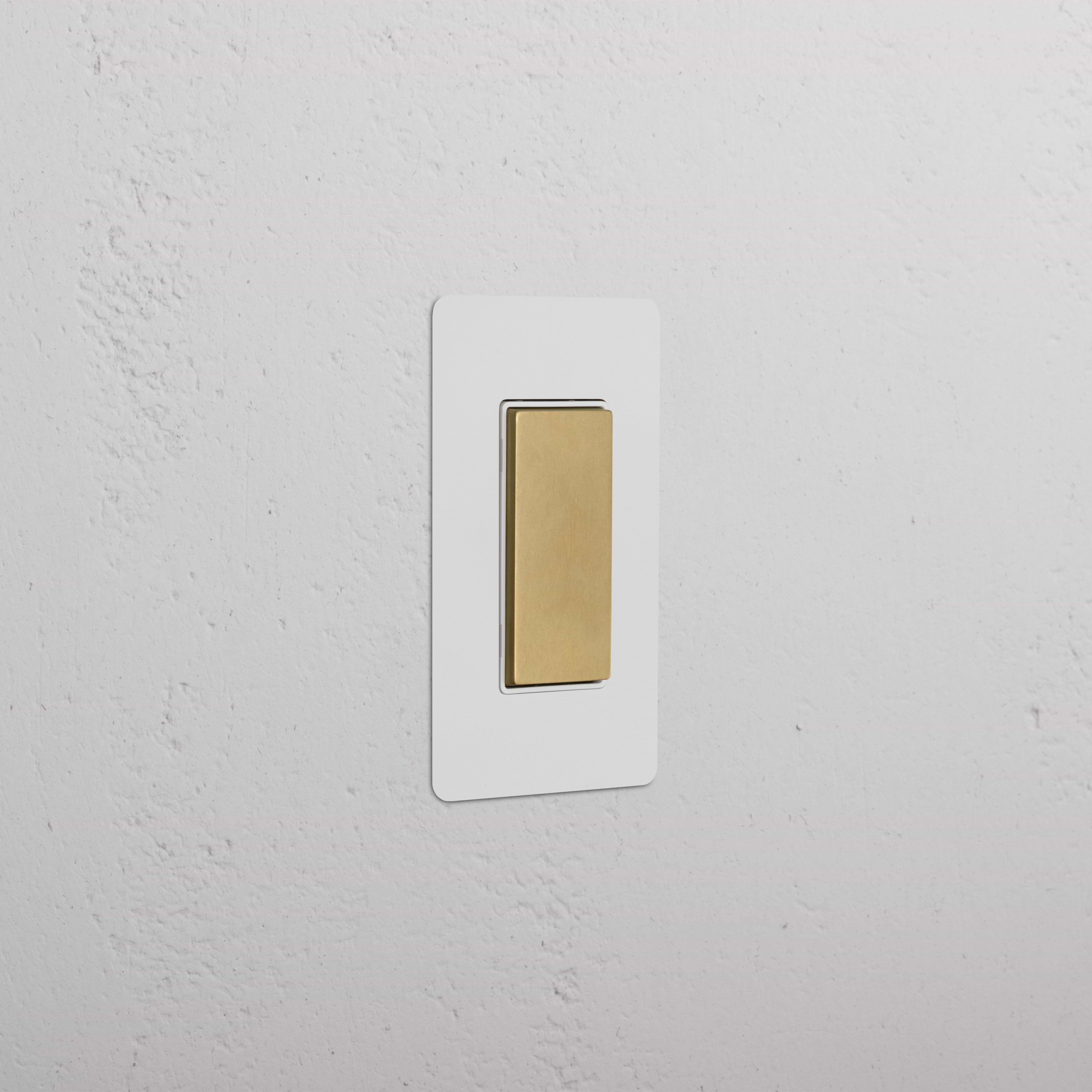 Kew 1G Center Retractive Rocker Switch in paintable antique brass white on a white background.