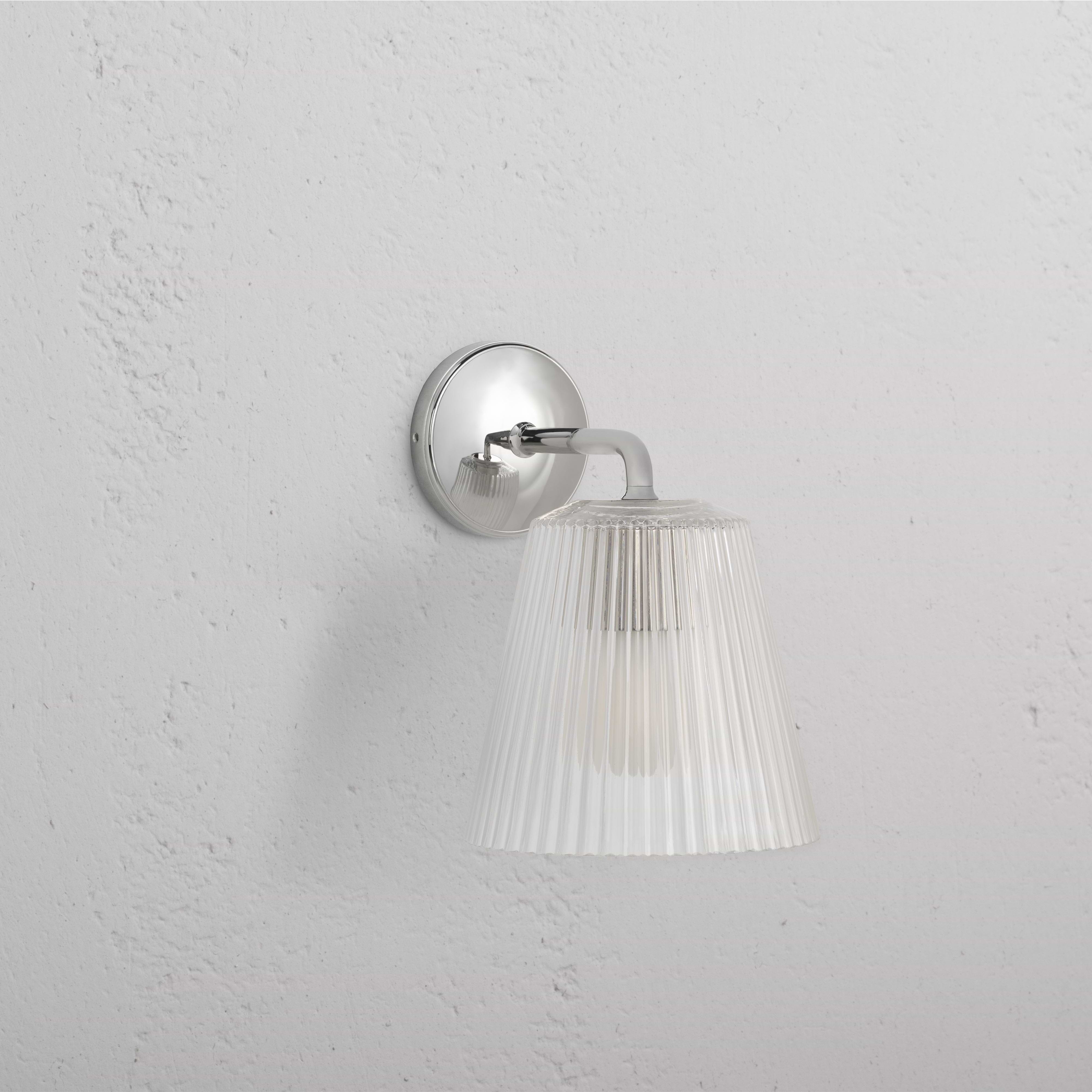 Large Richmond Wall Light with fluted clear glass shade and polished nickel base mounted on a white wall.