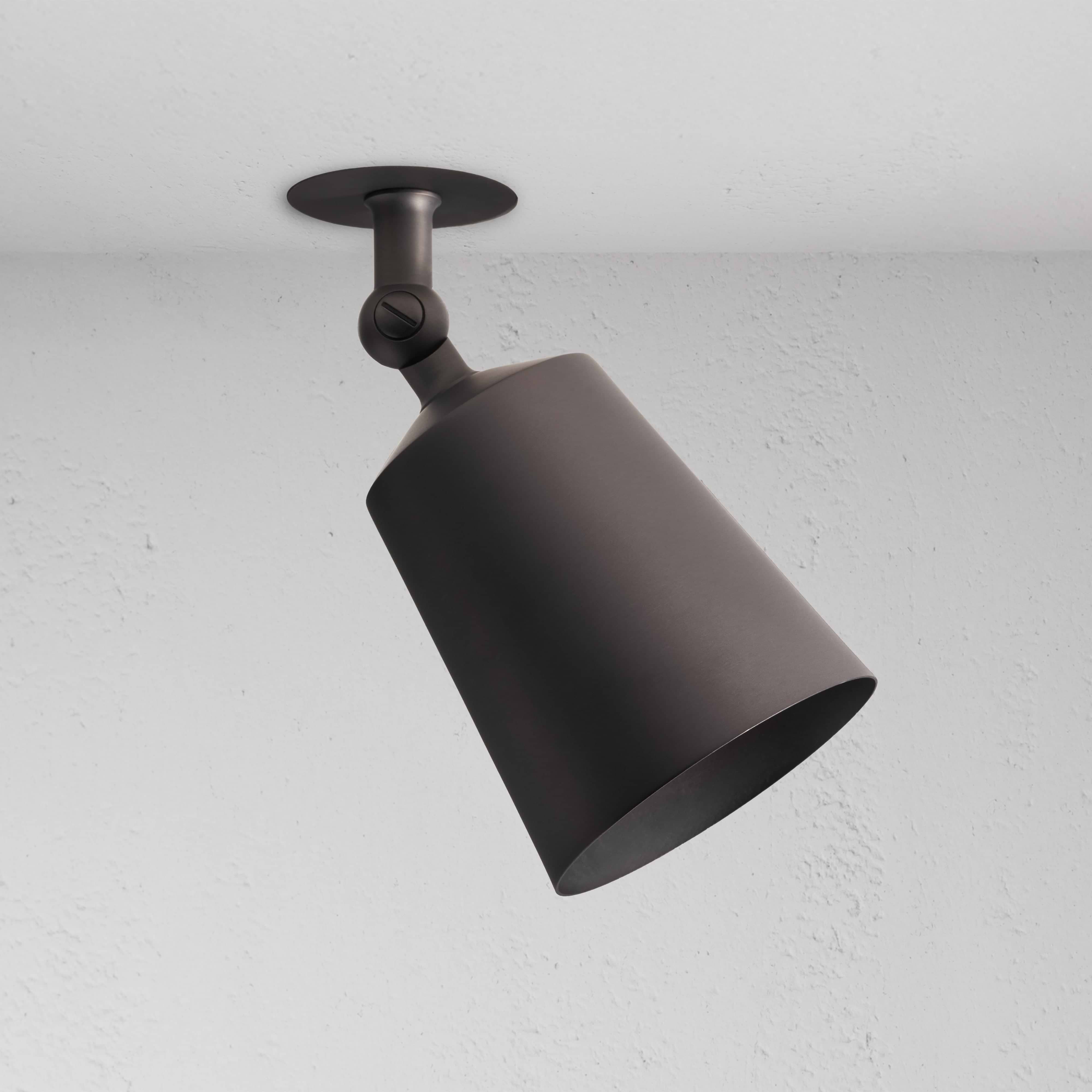 Bronze Perryn Single 70mm Spotlight mounted on white ceiling, angled downward in a modern design.