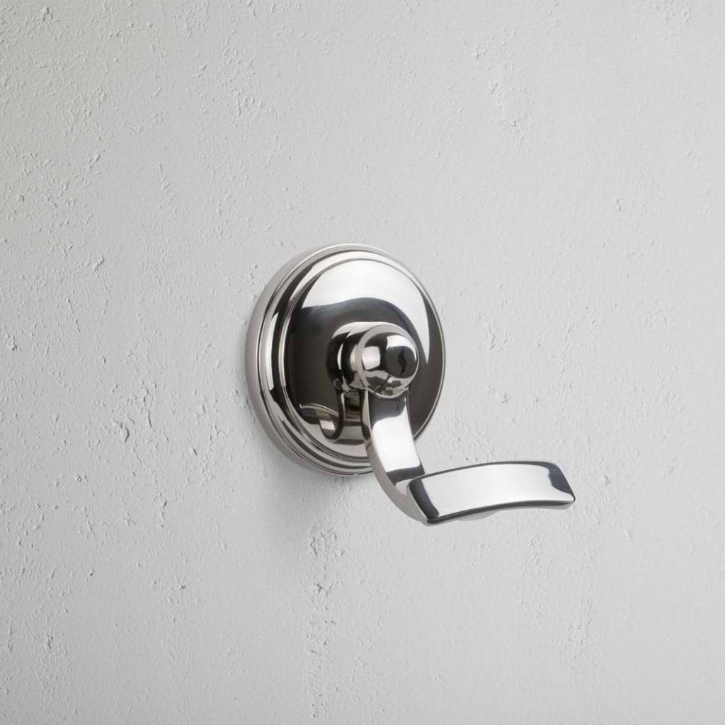 Polished nickel wall-mounted hook with a sleek, modern design, called the Portland Hook.