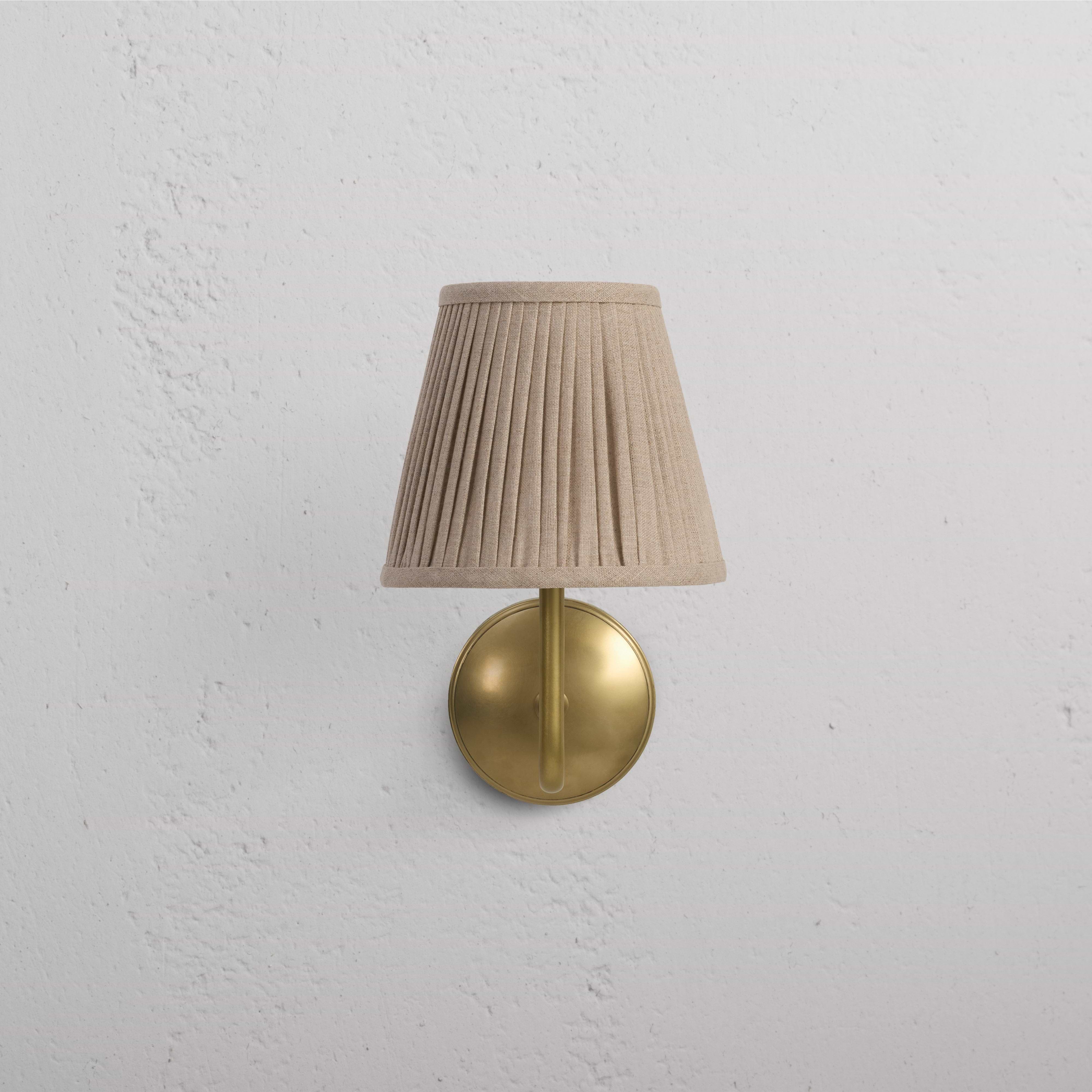 Malvern Medium Wall Light in natural beige with pleated lampshade and antique brass base, wall-mounted.