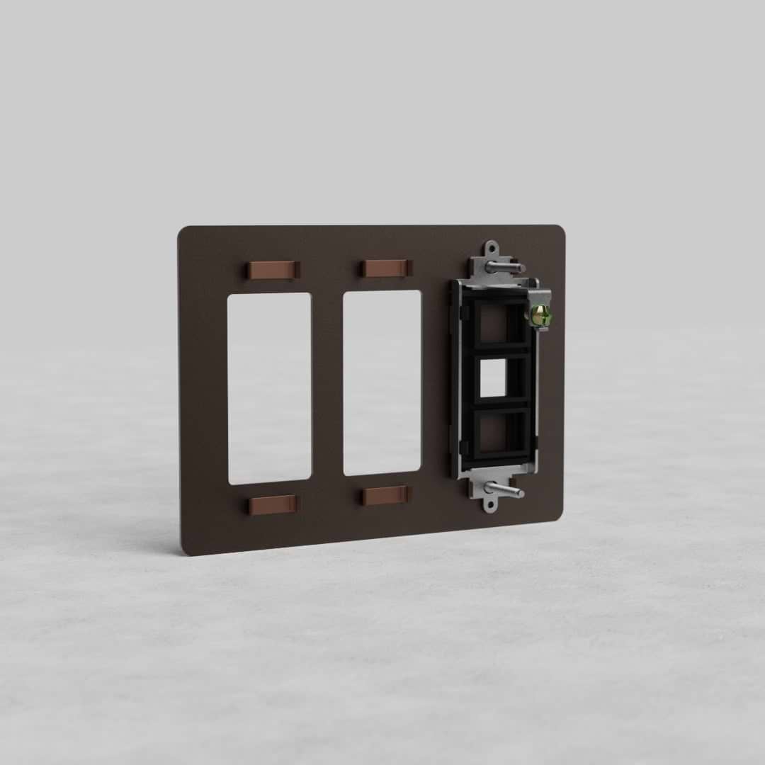 Bronze 3-gang wall plate with two outlets and keystone opening, Kew US model, on light gray surface.