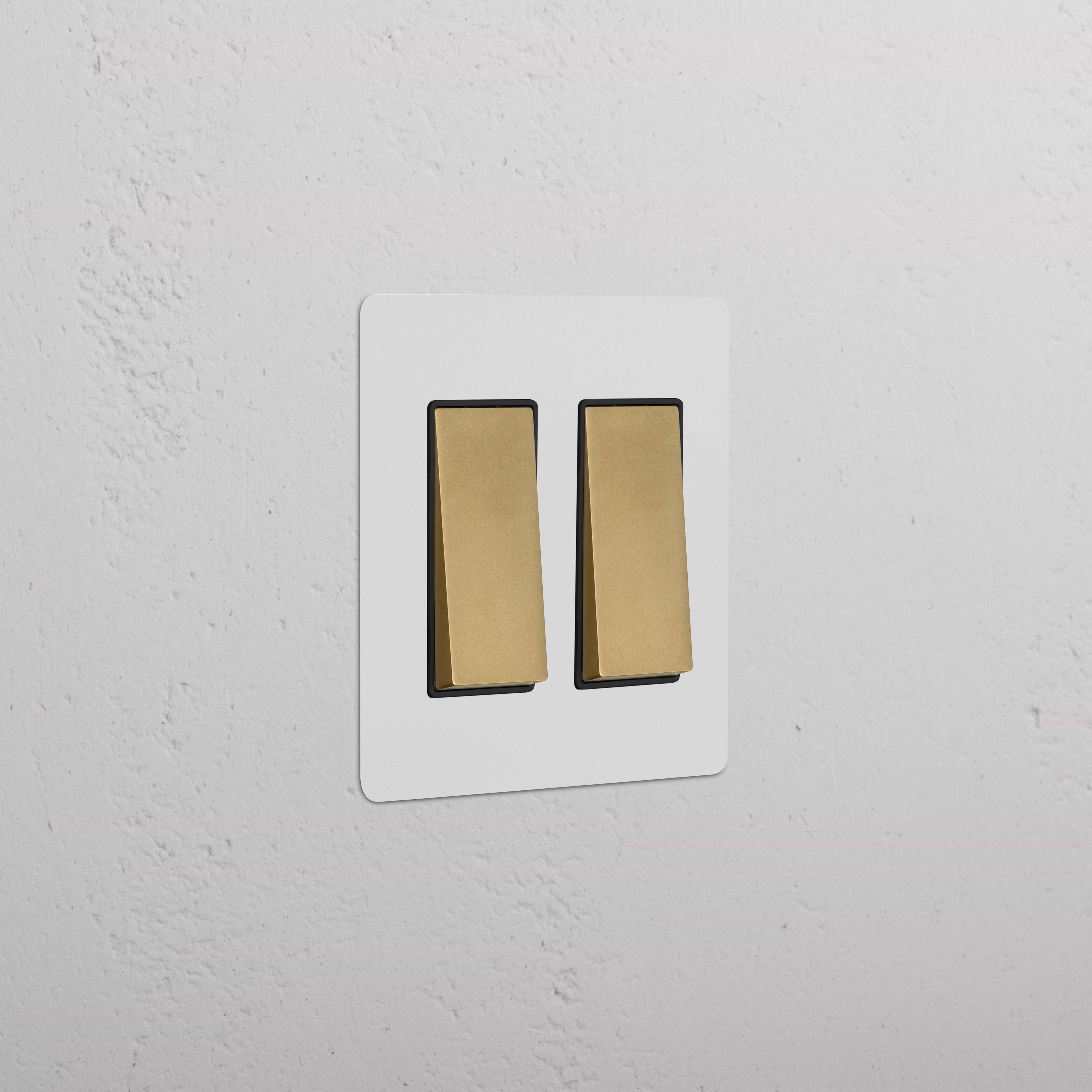 Kew 2G Rocker Switch in paintable antique brass black finish, mounted on a wall.
