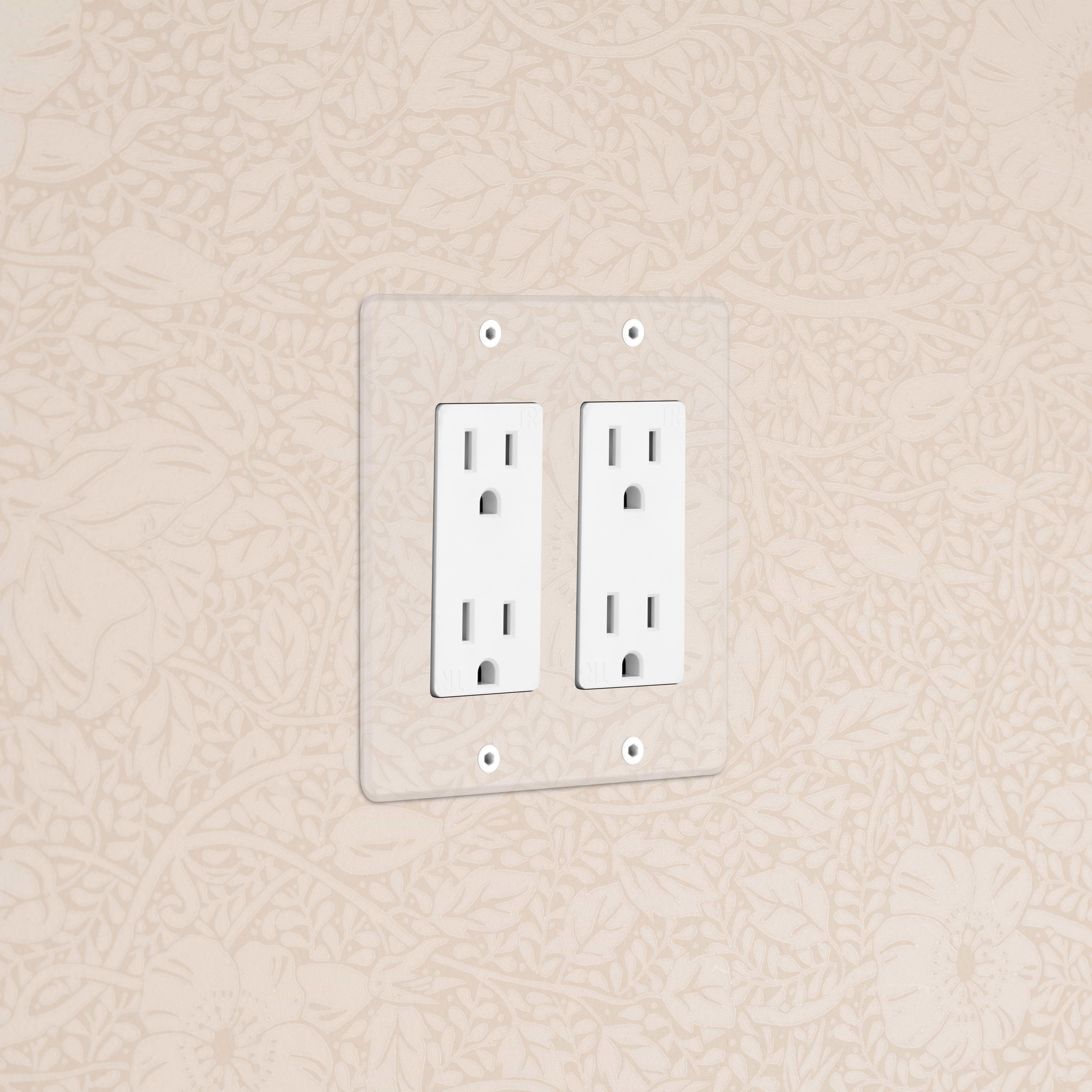 Kew 2G Outlet in clear white finish, double power socket installed on a beige wall with floral pattern.