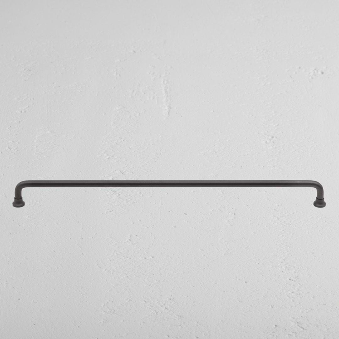 Large bronze Sycamore furniture handle with a sleek, modern design against a neutral background.