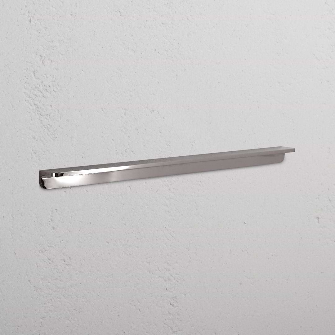 Large polished nickel Oxford Furniture Handle with a sleek, modern design mounted horizontally on a white surface.
