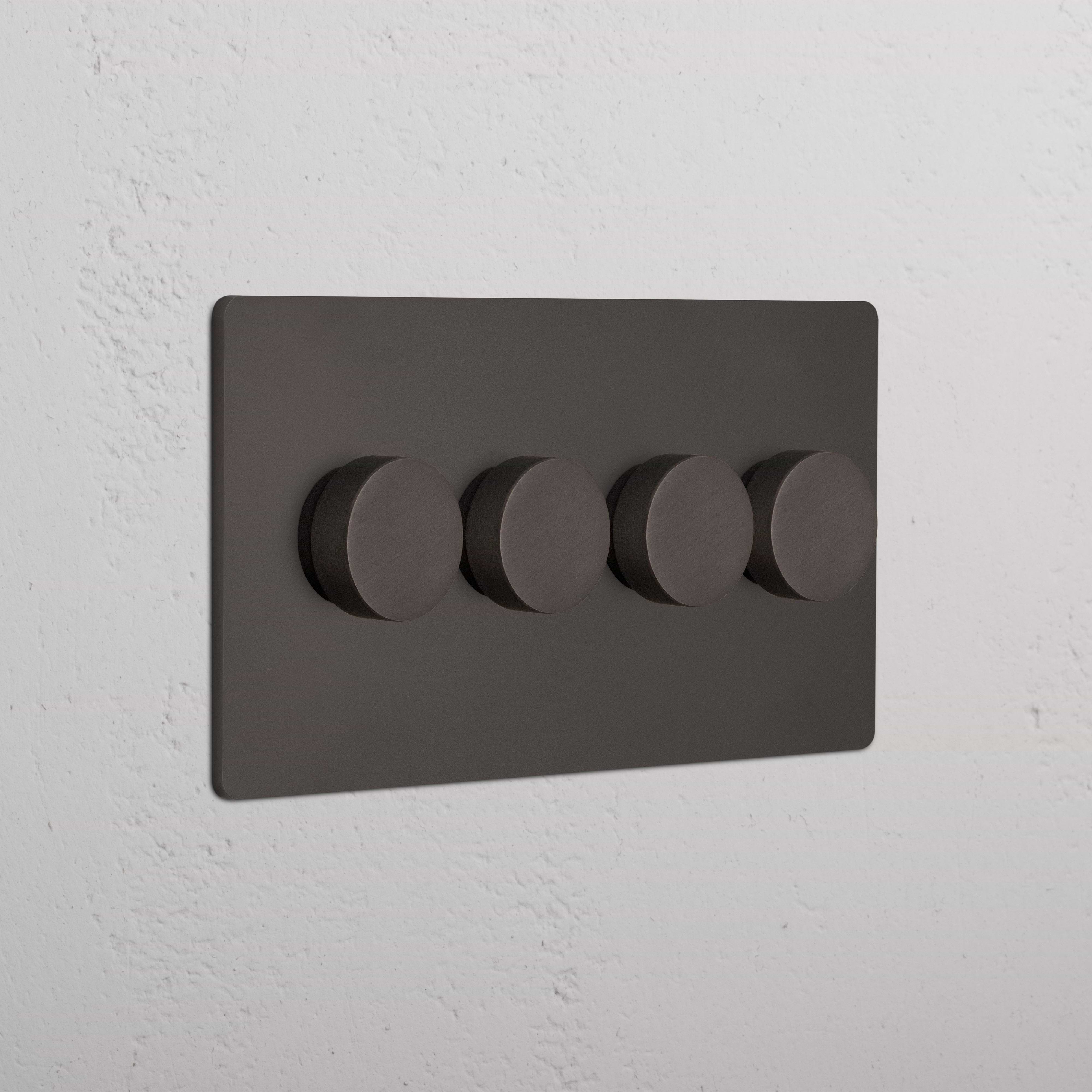 Bronze Grove 4G Dimmer Switch with four round control knobs, mounted on a white textured wall.