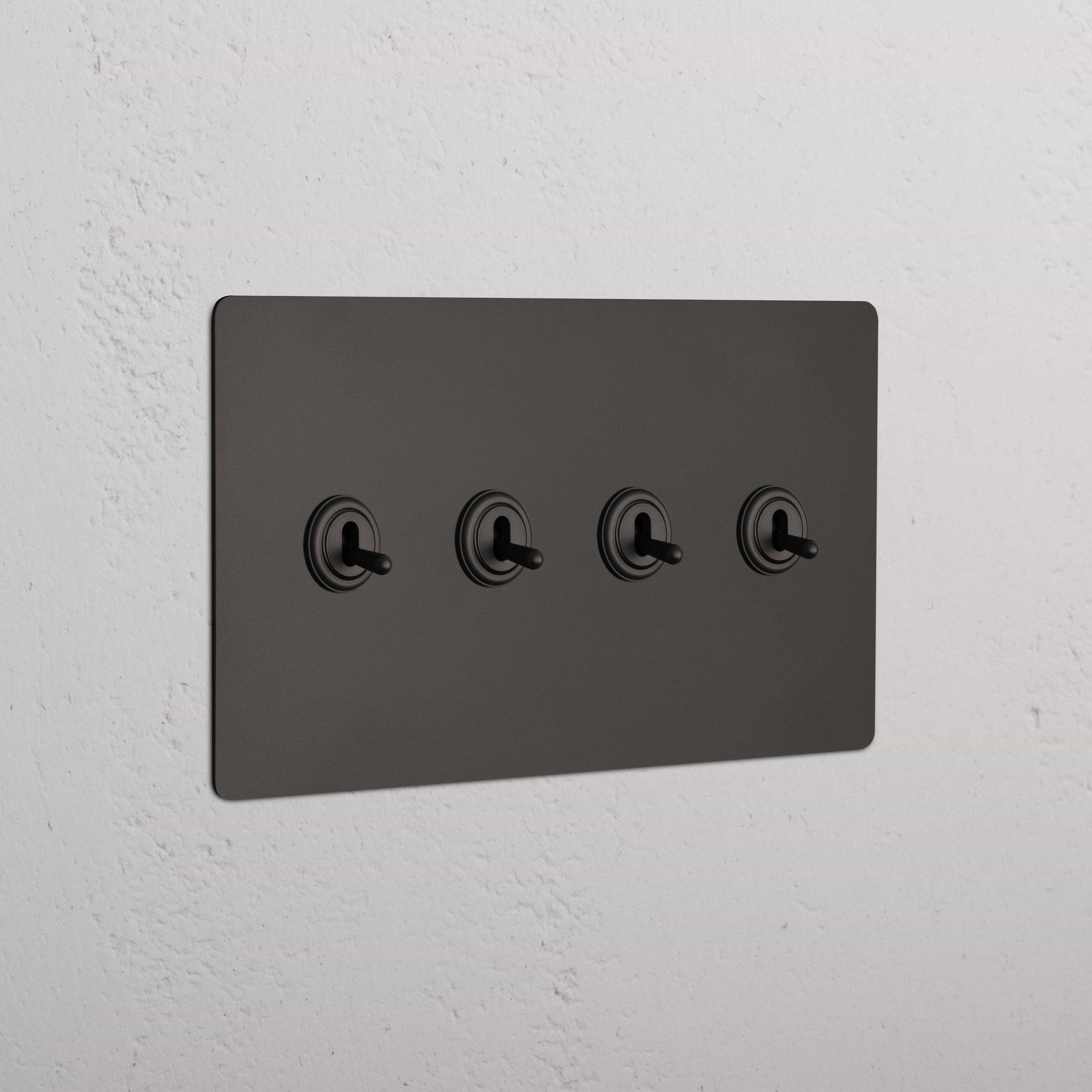 Kew 4G Toggle Switch - Bronze with four bronze toggles on a switch panel, mounted on a wall.