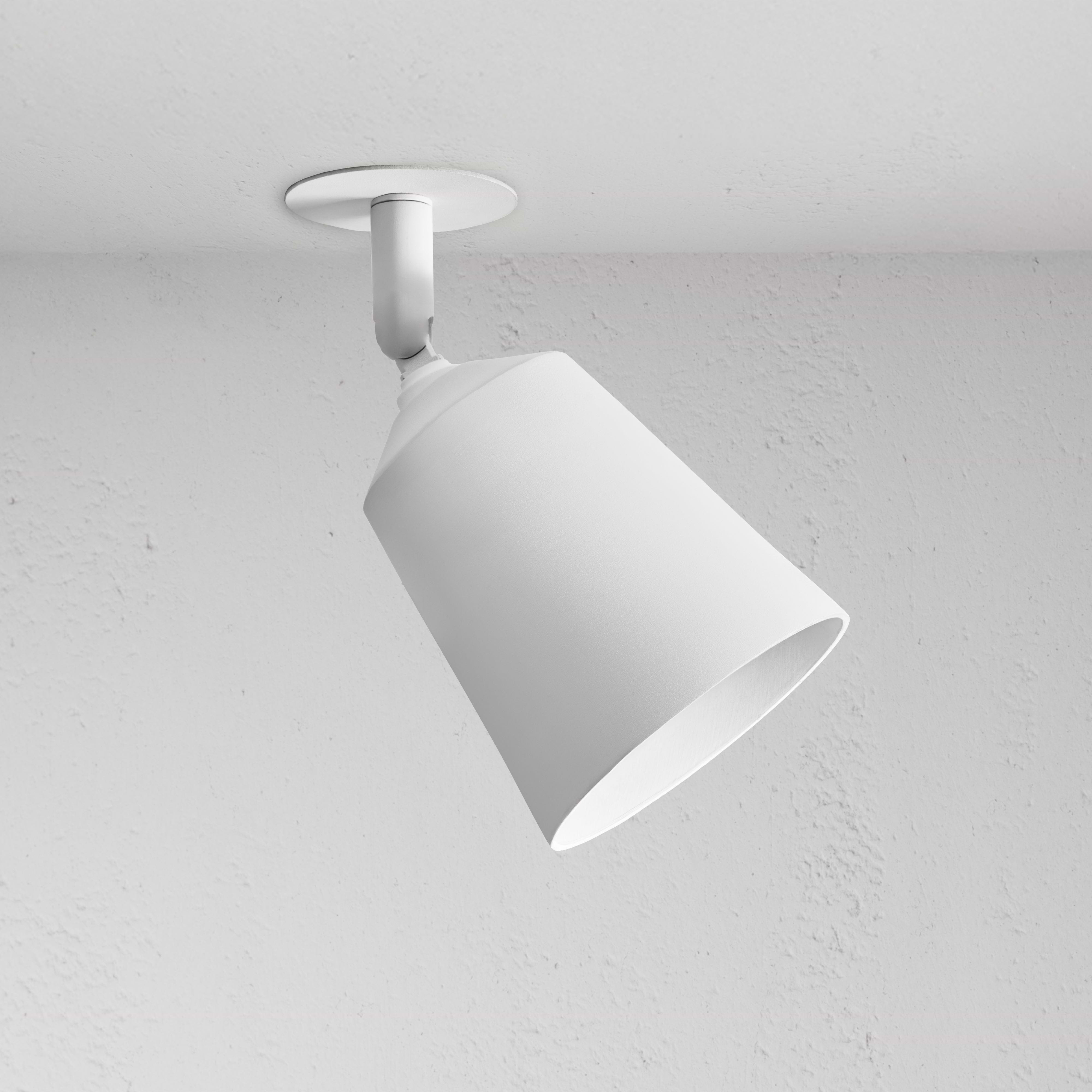 Pembroke Single 70mm Spotlight, white cone-shaped paintable ceiling light, angled downward on a ceiling.
