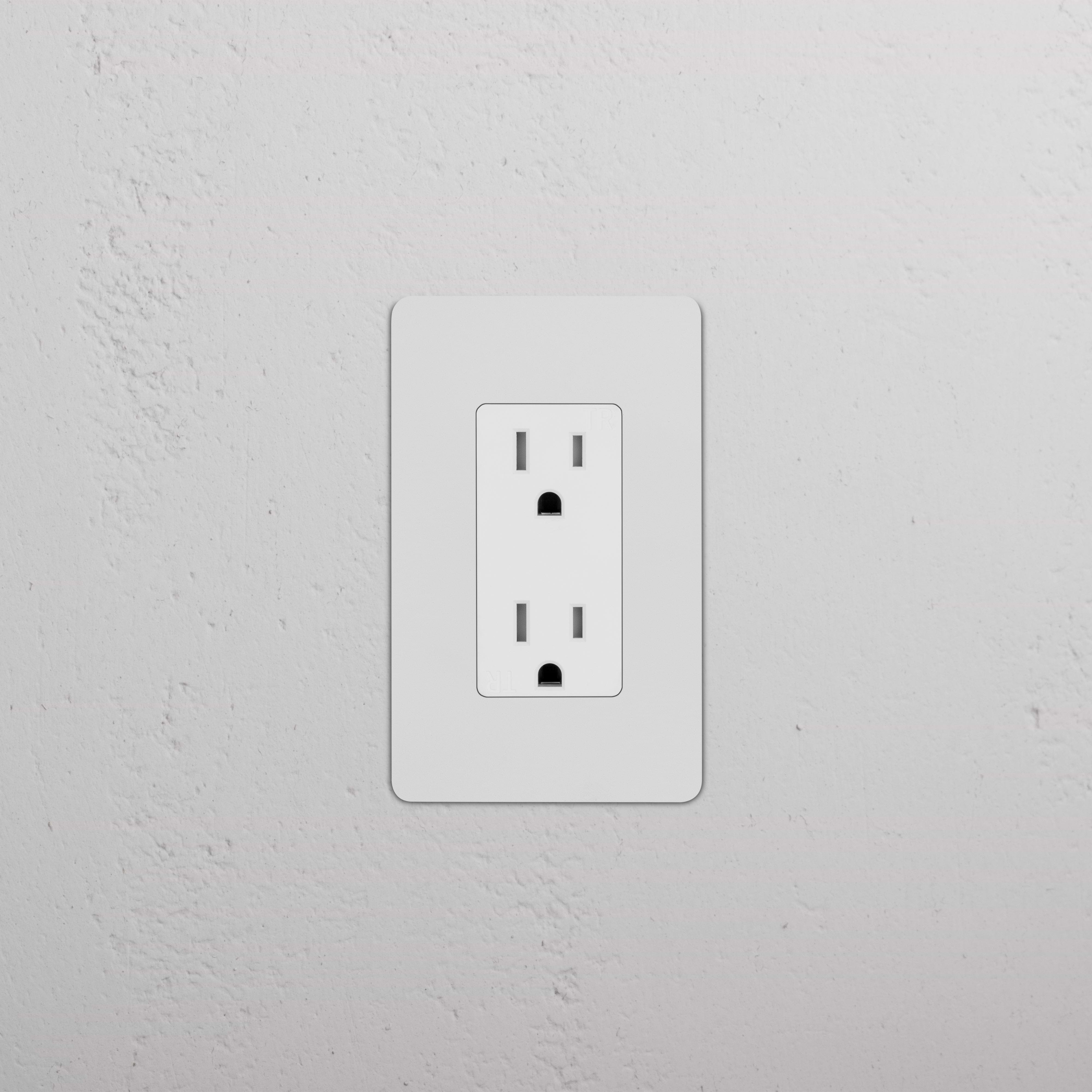 Kew 1G 15A electrical outlet in paintable white finish, mounted on a textured white wall.