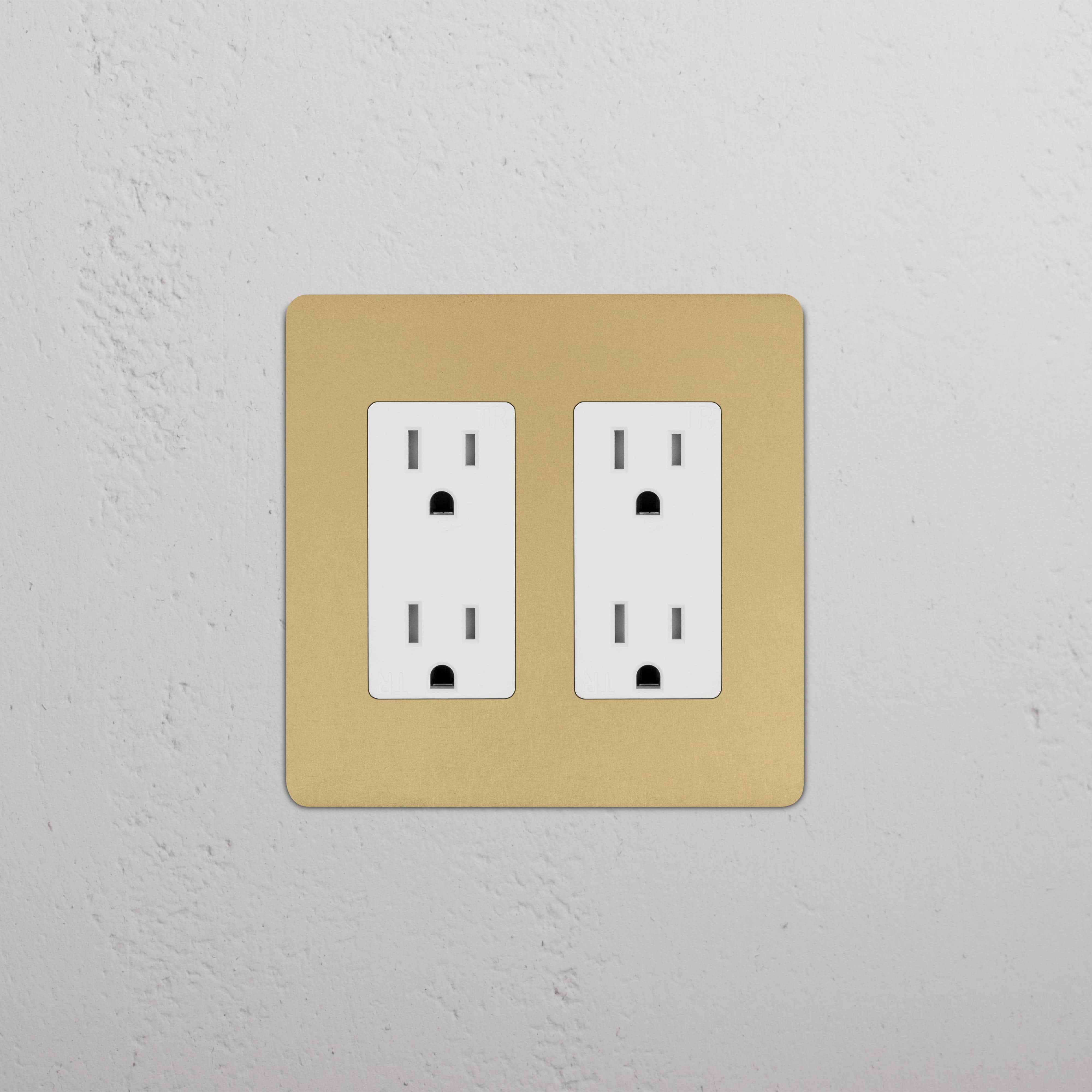 Kew 2G Outlet in antique brass white finish with two plug sockets, shown installed on a white wall.