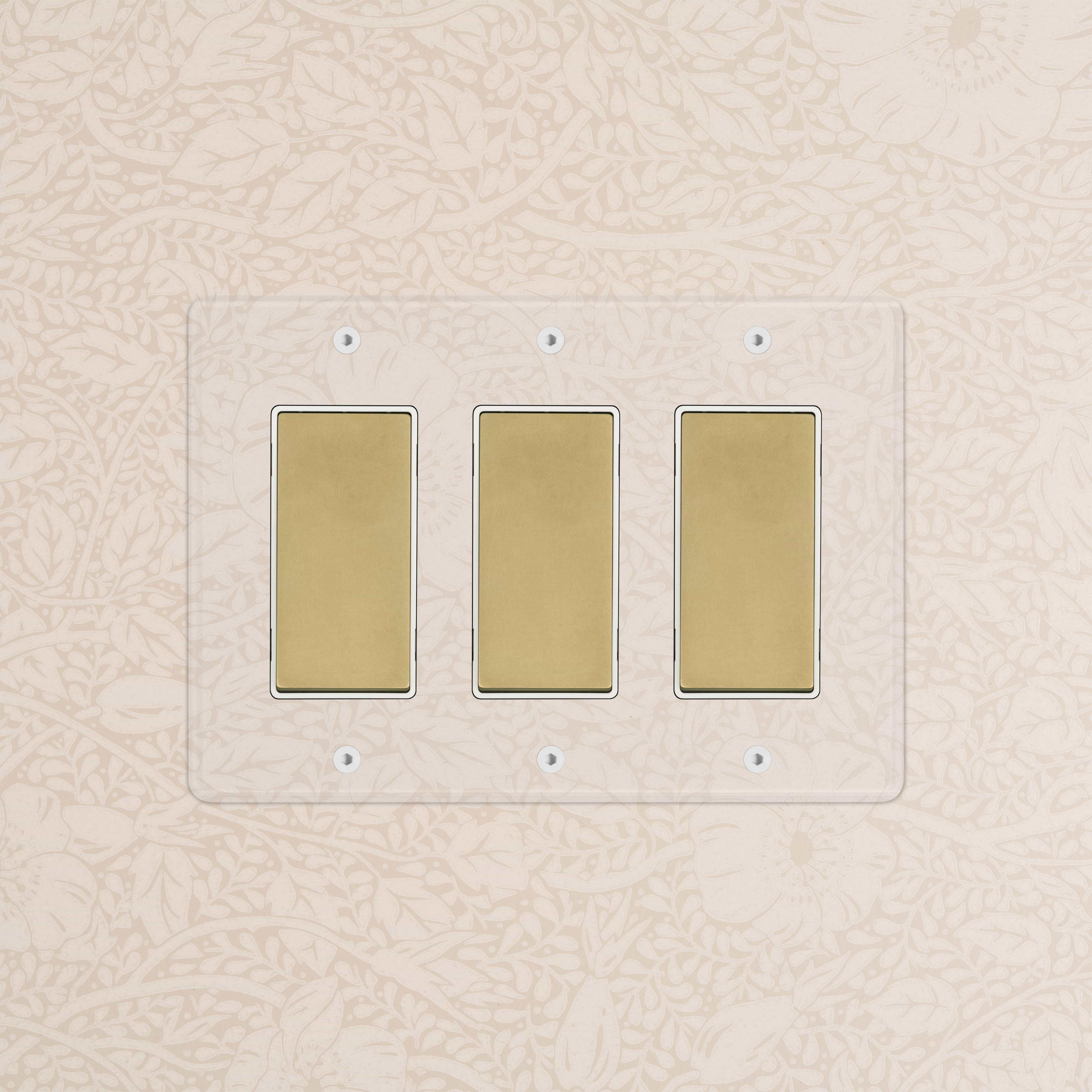 Kew 3G Rocker Switch in clear antique brass with white plate and three rectangular gold-tone switches.