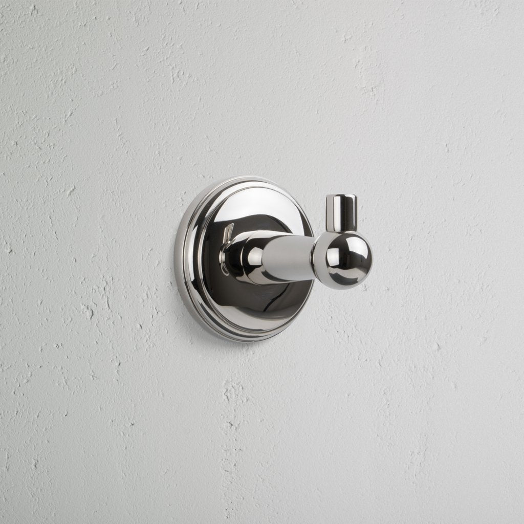 Hyde Hook in polished nickel with a round backplate, featuring a sleek, modern cylindrical design.