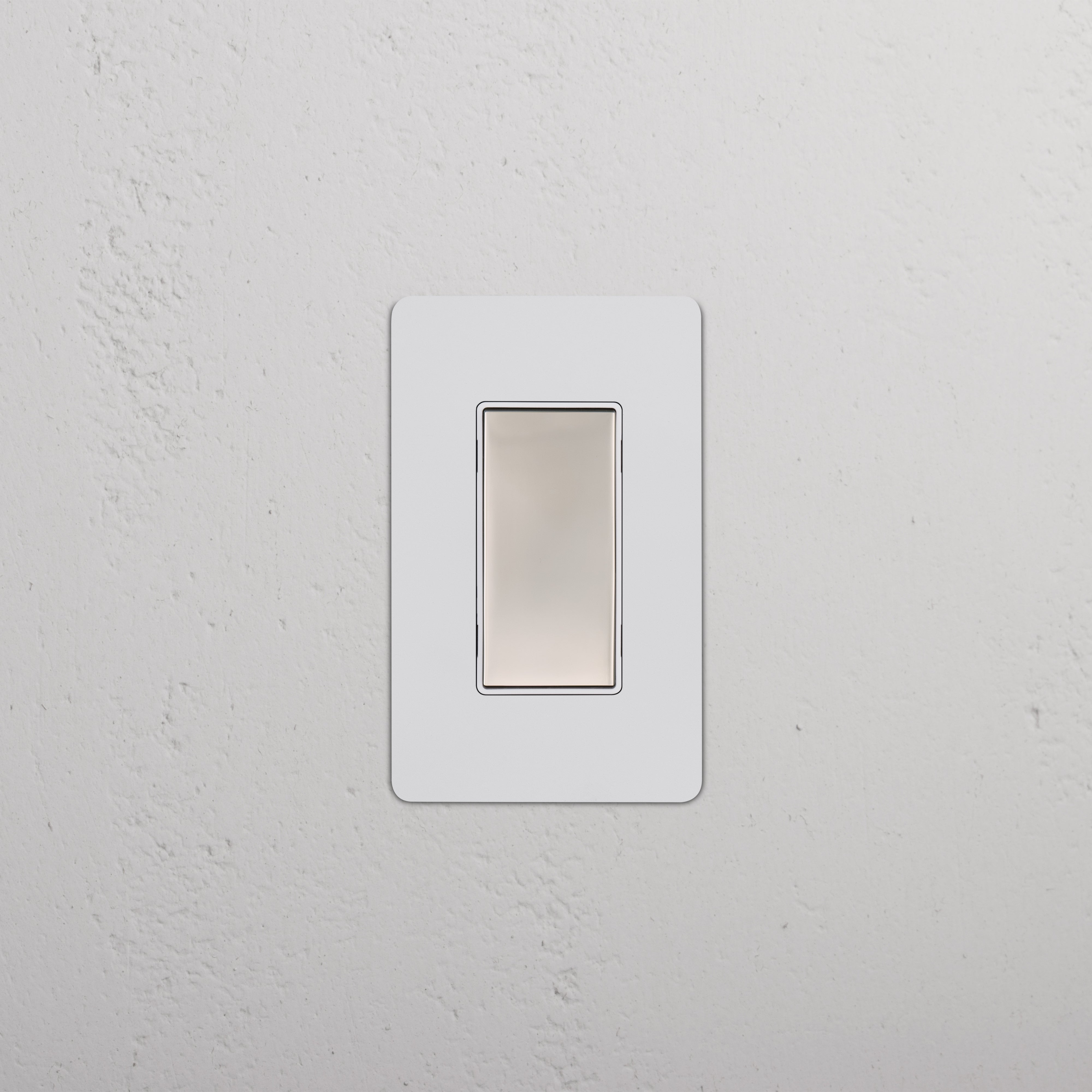 Kew 1G Center Retractive Rocker Switch in Paintable Polished Nickel White, rectangular design, wall-mounted.