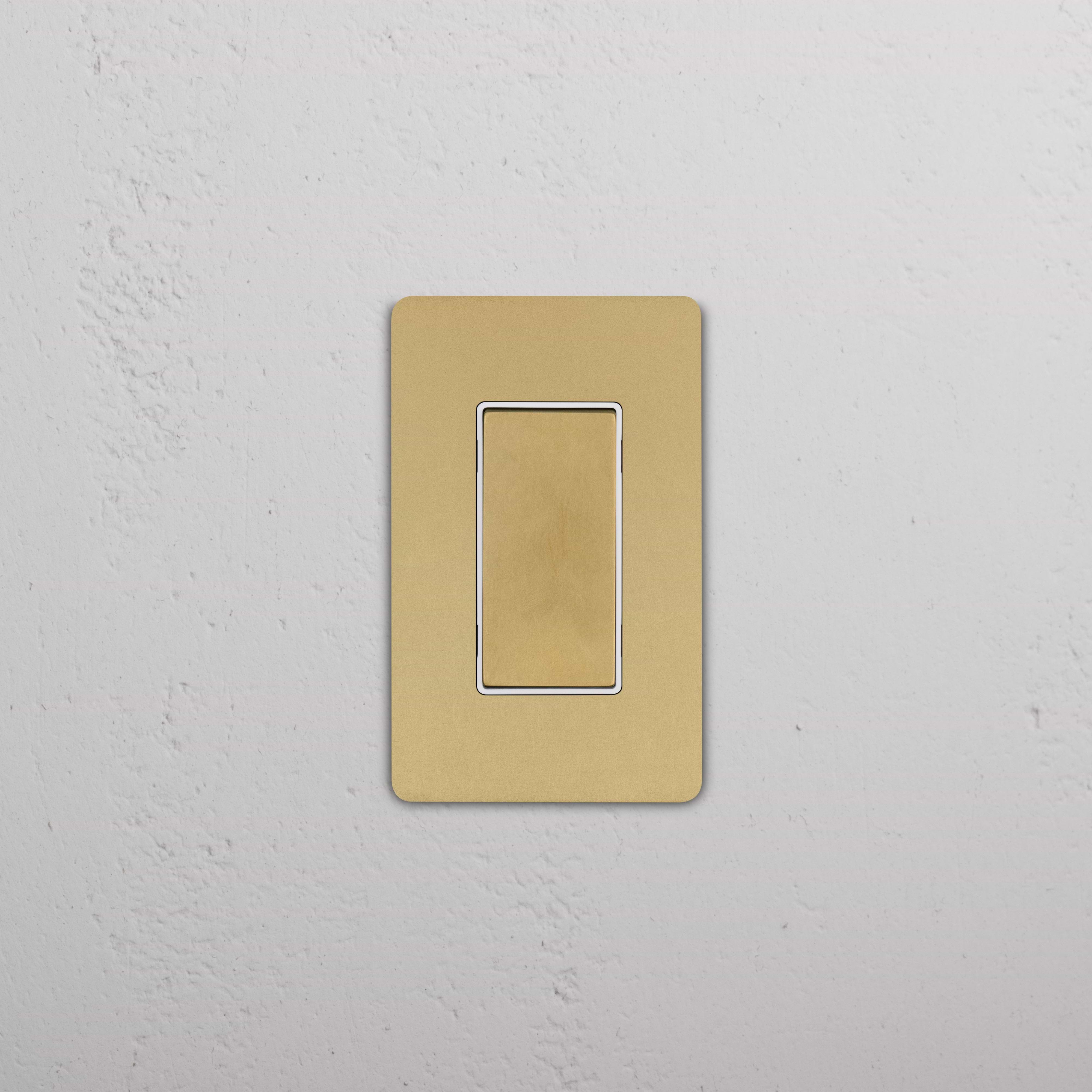 Grove 1G Center Retractive Rocker Switch in Antique Brass White with a rectangular, modern plate.