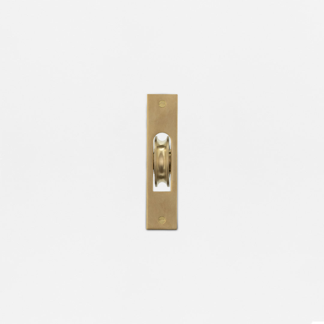 Belmont Single Hung Window Pulley in Antique Brass with exposed wheel, displayed on a white background.