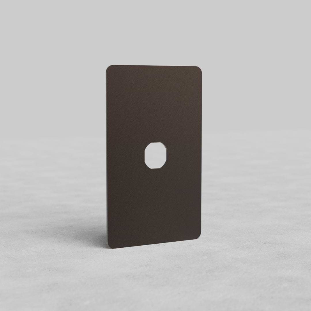 Bronze 1G Switch Plate Kew US with central switch aperture, displayed on a light gray surface.