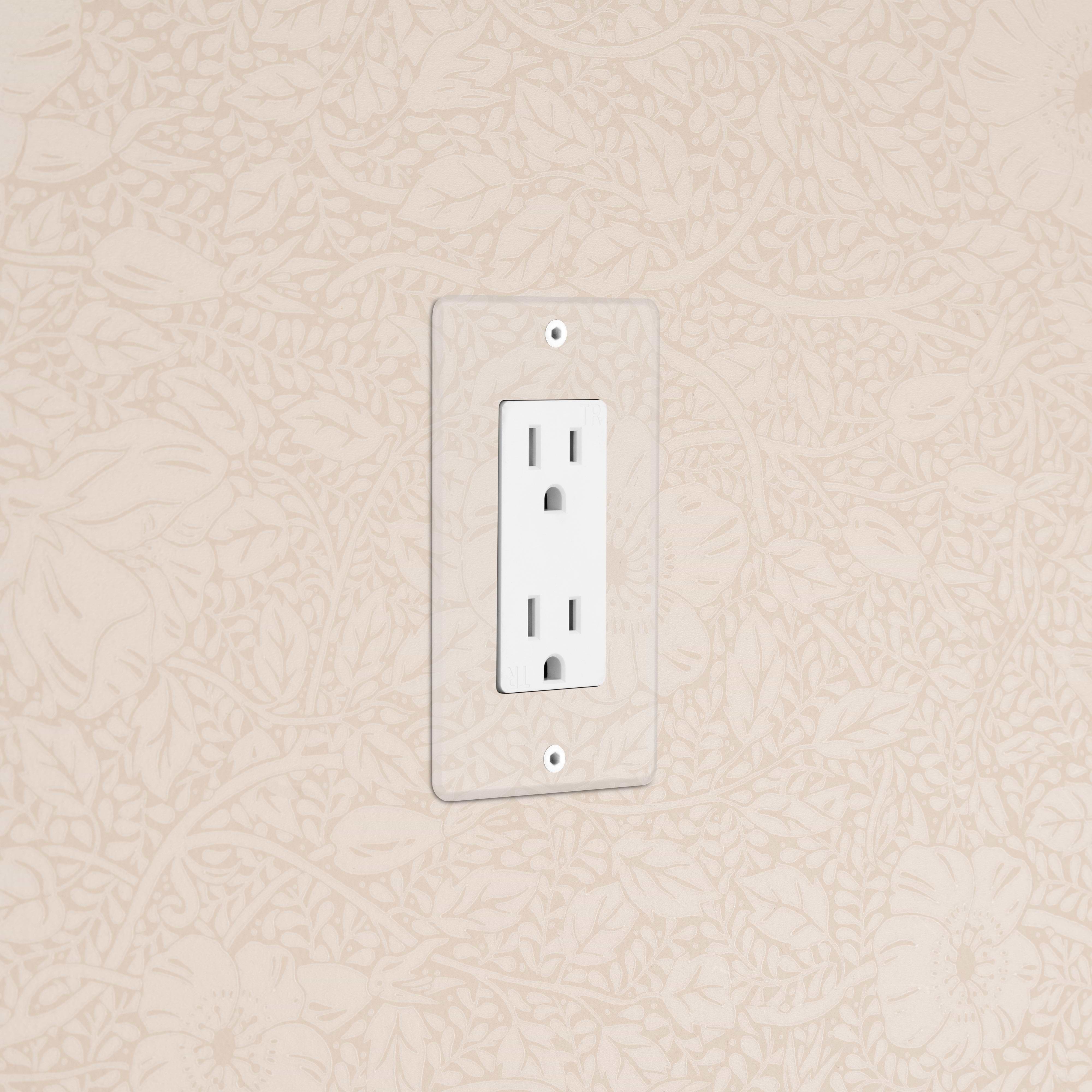 Kew 1G 15A Outlet in Clear White with two sockets and a clear cover plate, mounted on a textured wall.