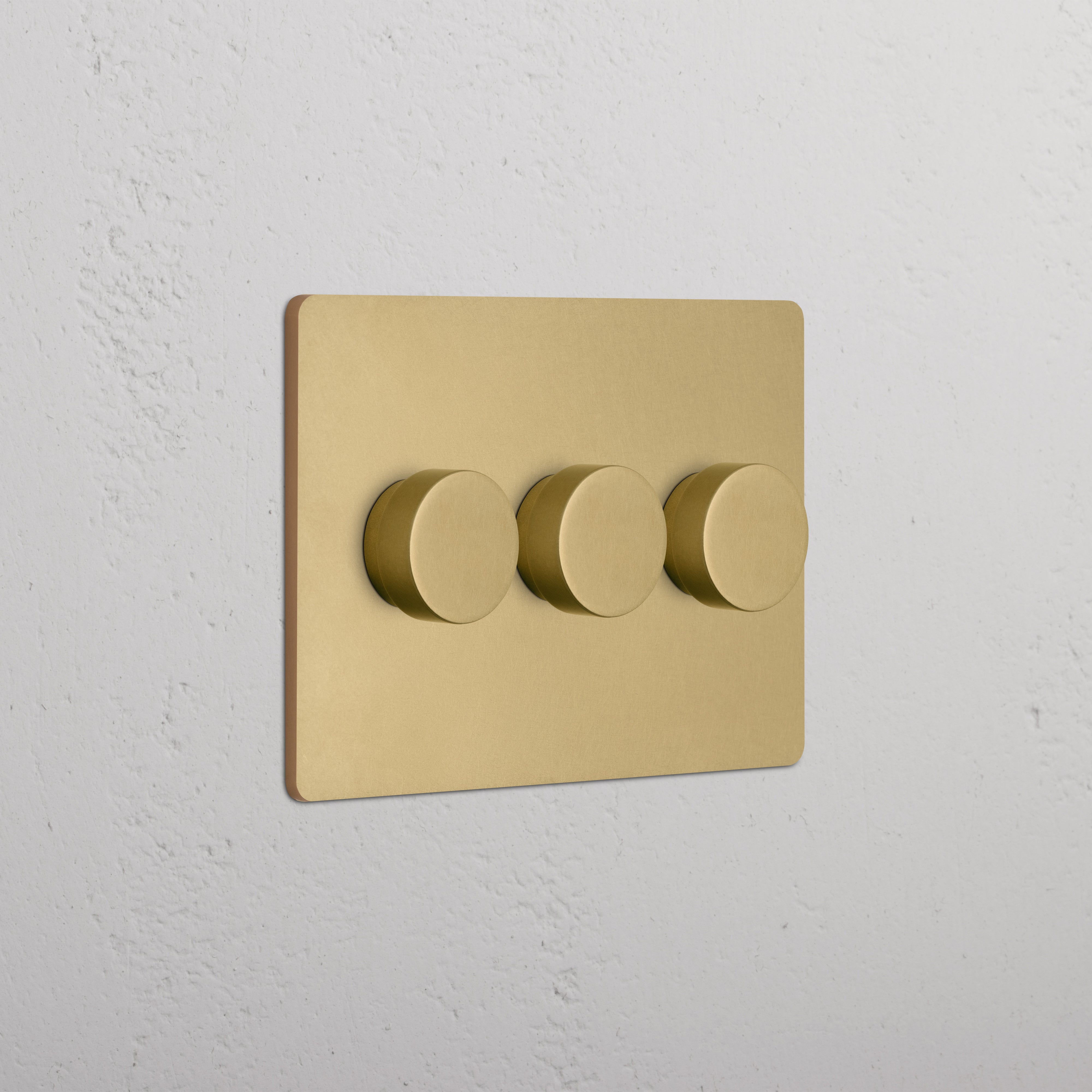 Grove 3G Dimmer Switch in antique brass with three round dimmer knobs on a brass wall plate.