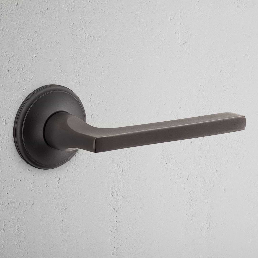 Clayton Unsprung Passage Door Handle Set in bronze finish with a sleek, minimalist design and round base plate.