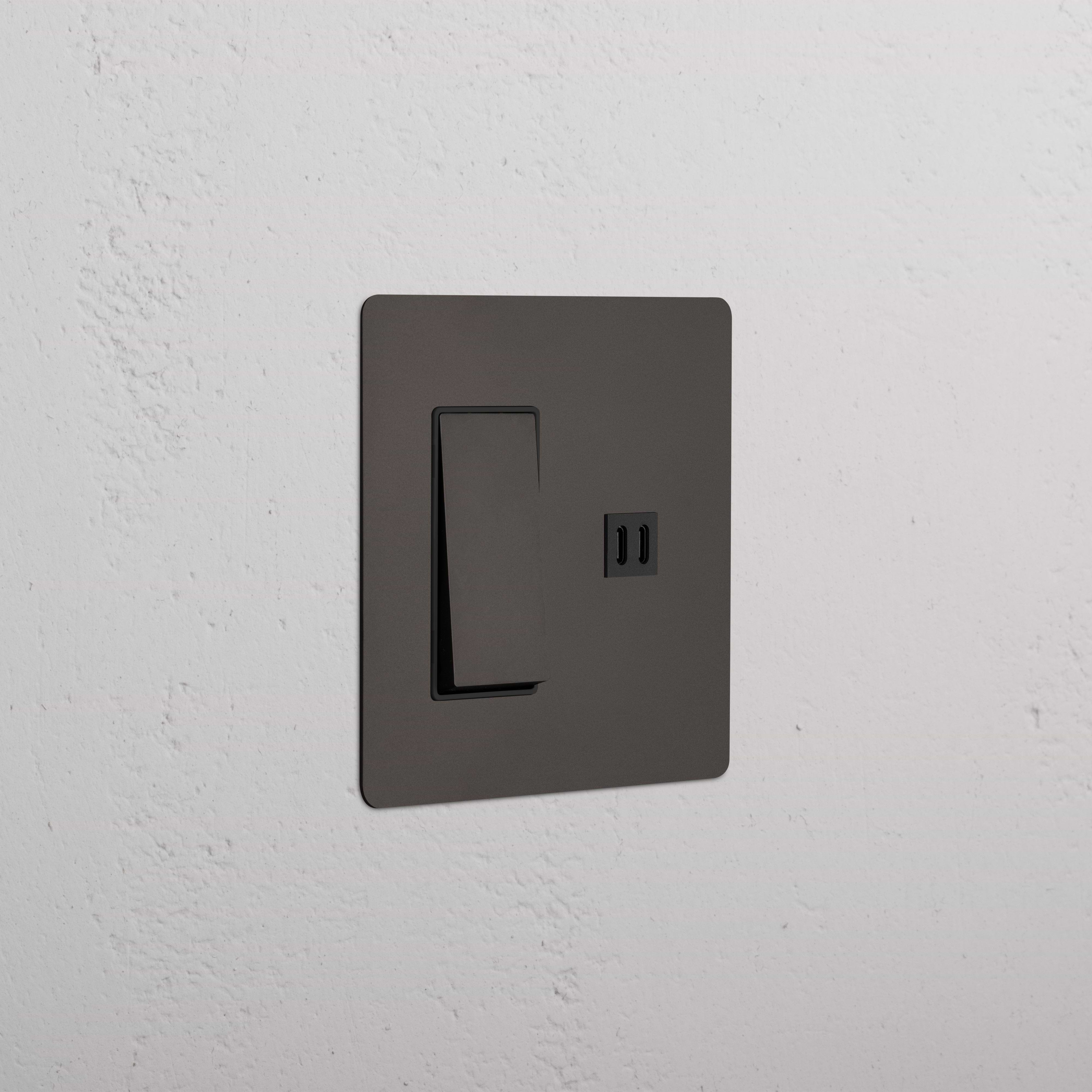 Kew 2G Rocker Switch & Fast Charge USB in Bronze Black with a modern rectangular plate on a wall.