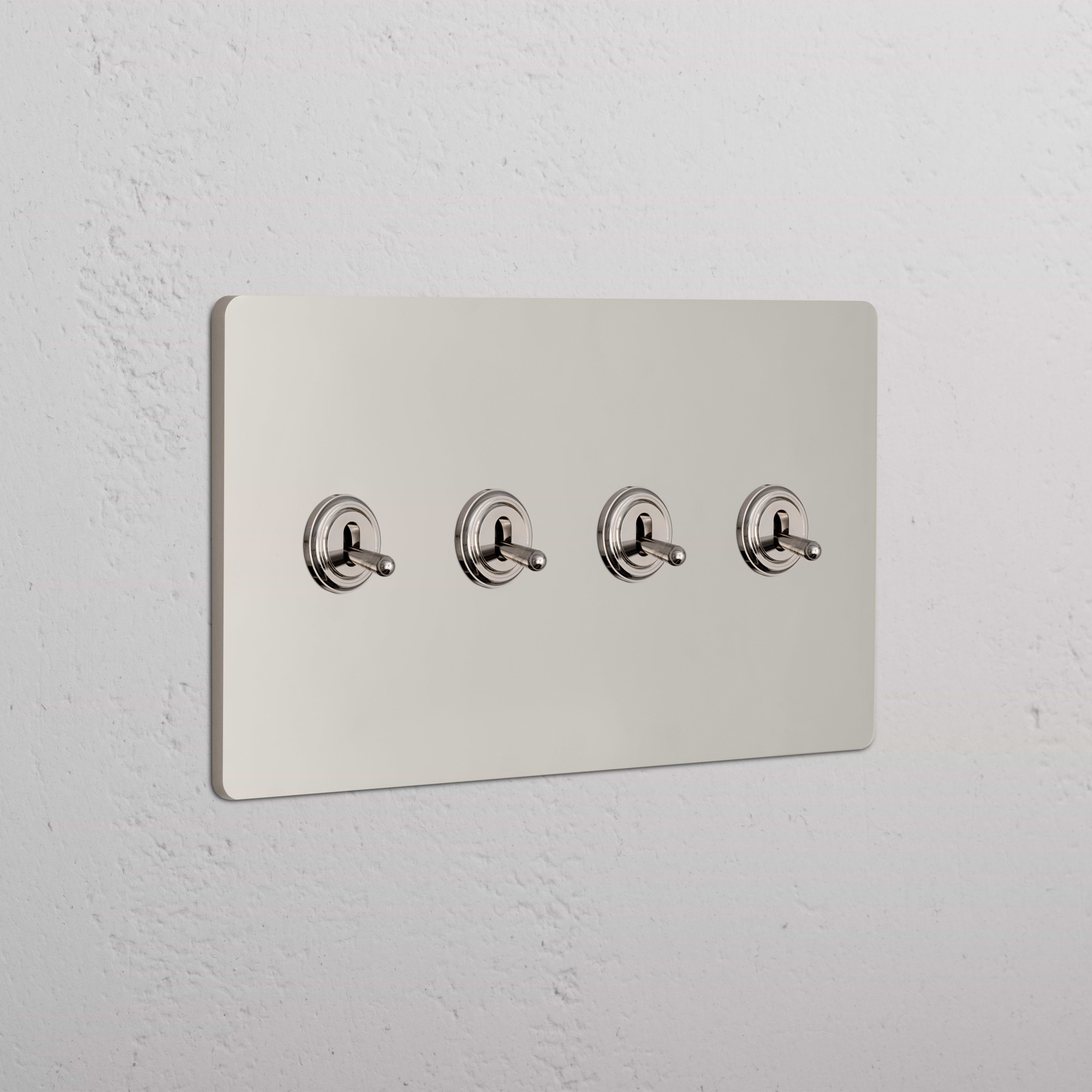 Grove 4G Toggle Switch in polished nickel with four horizontally aligned toggles on a metallic wall plate.