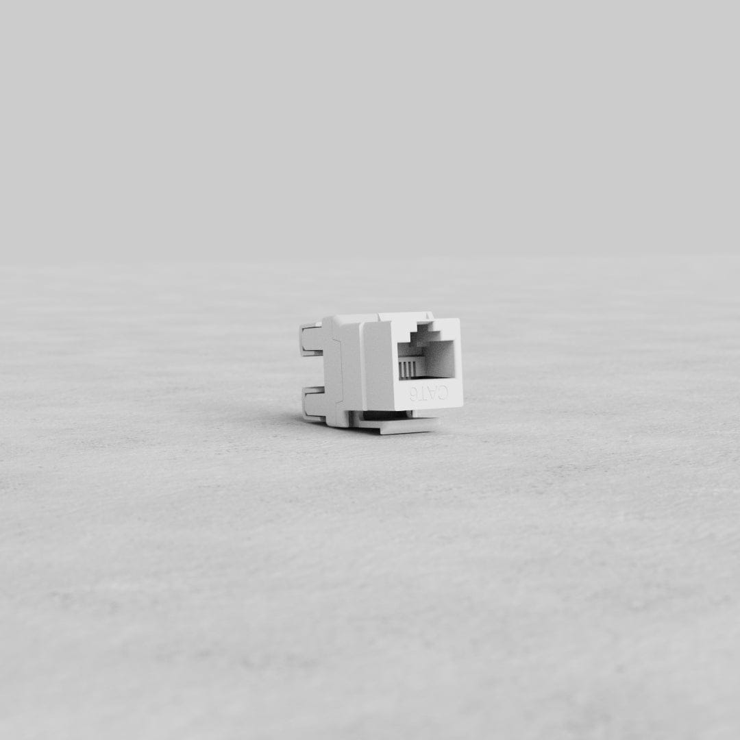 White CAT 6 Keystone Module jack designed for network cabling, shown on a plain gray background.