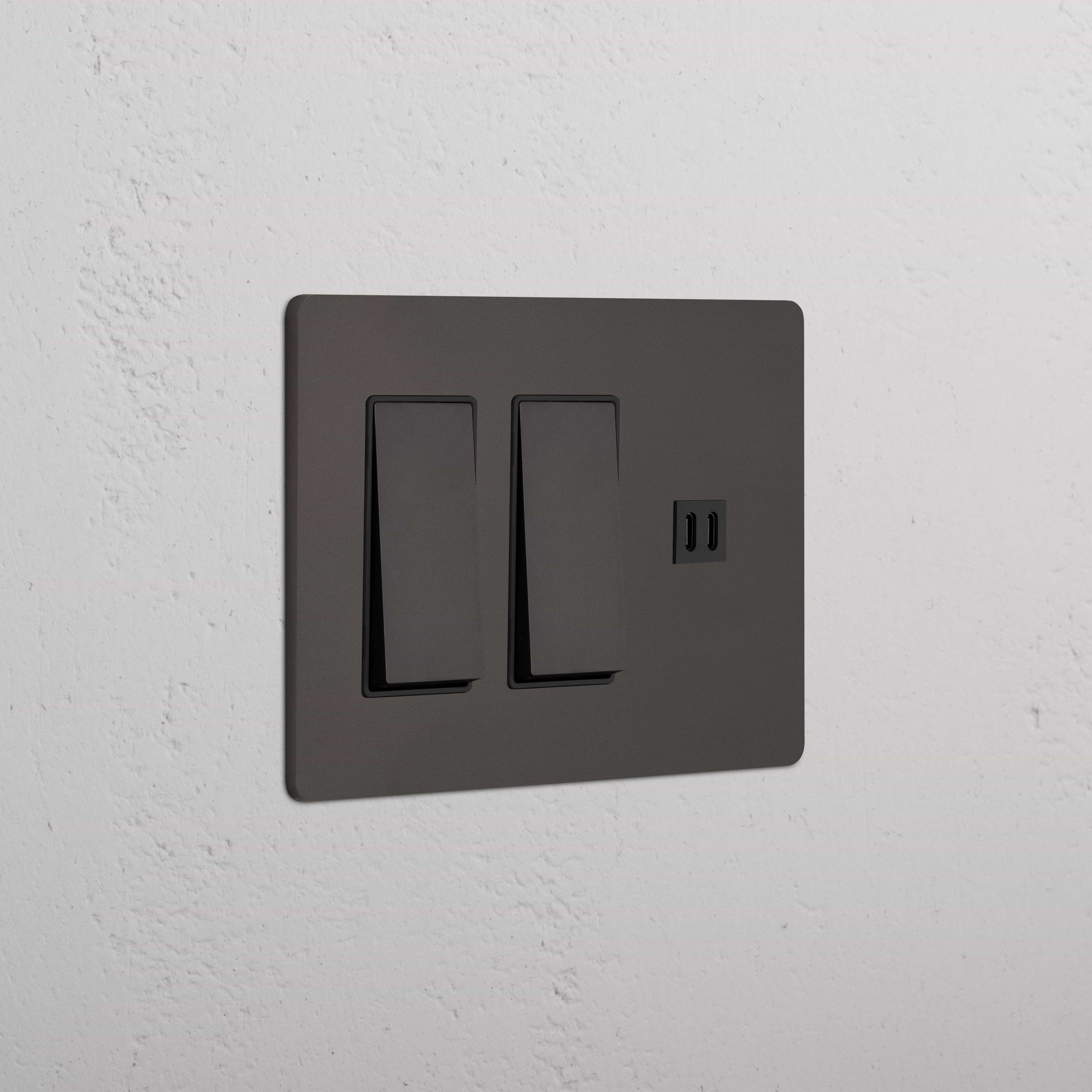 Bronze Black Grove 3G switch plate with two rocker switches and fast charge USB port, on a white wall.