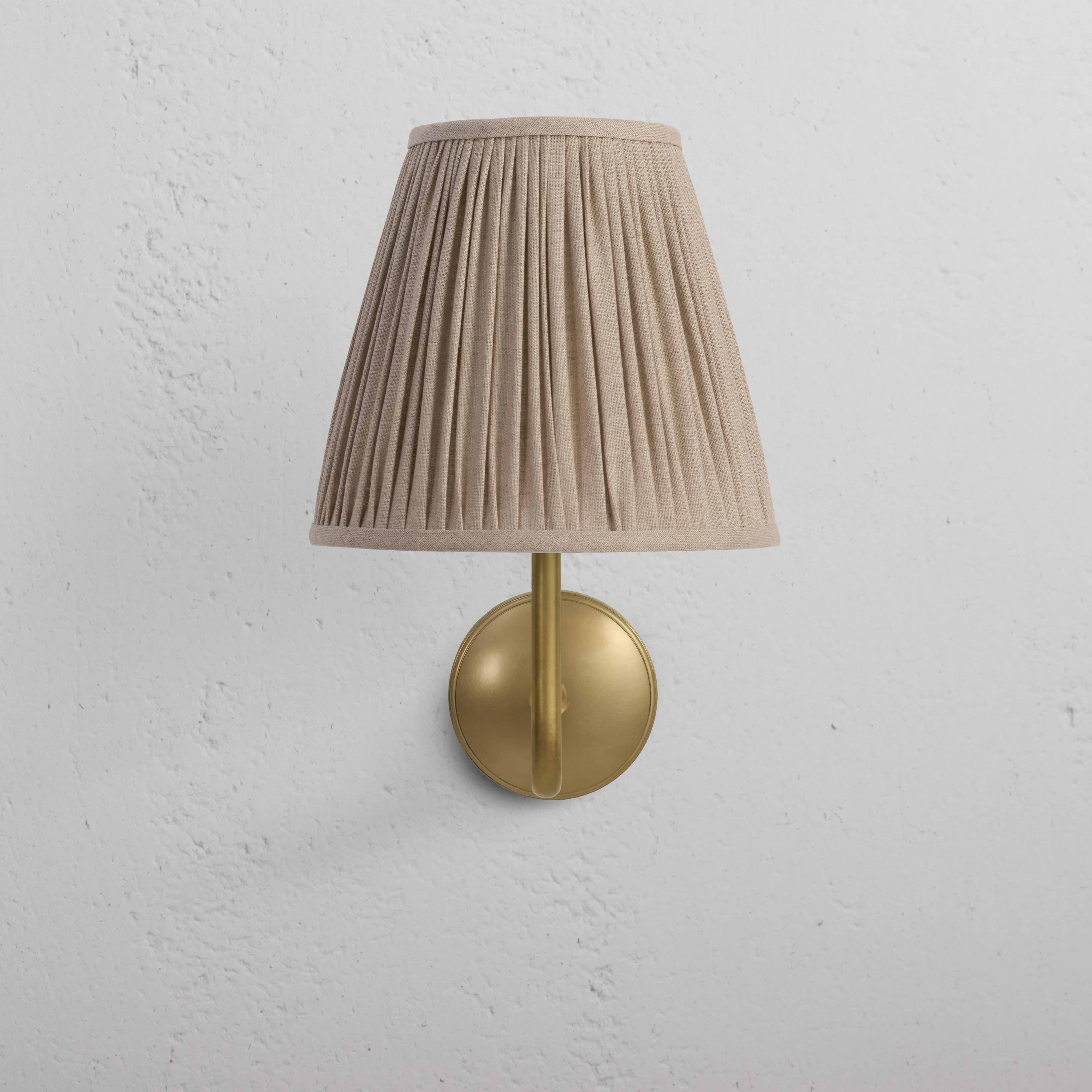Large Malvern Wall Light in natural beige with antique brass base and pleated fabric shade, wall-mounted.