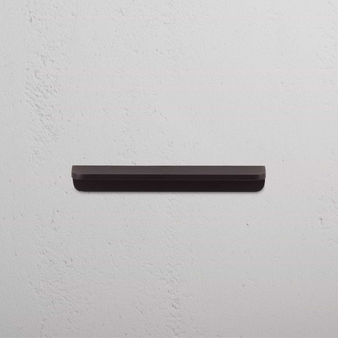 Small bronze Oxford furniture handle with a sleek, minimalist design against a plain white background.