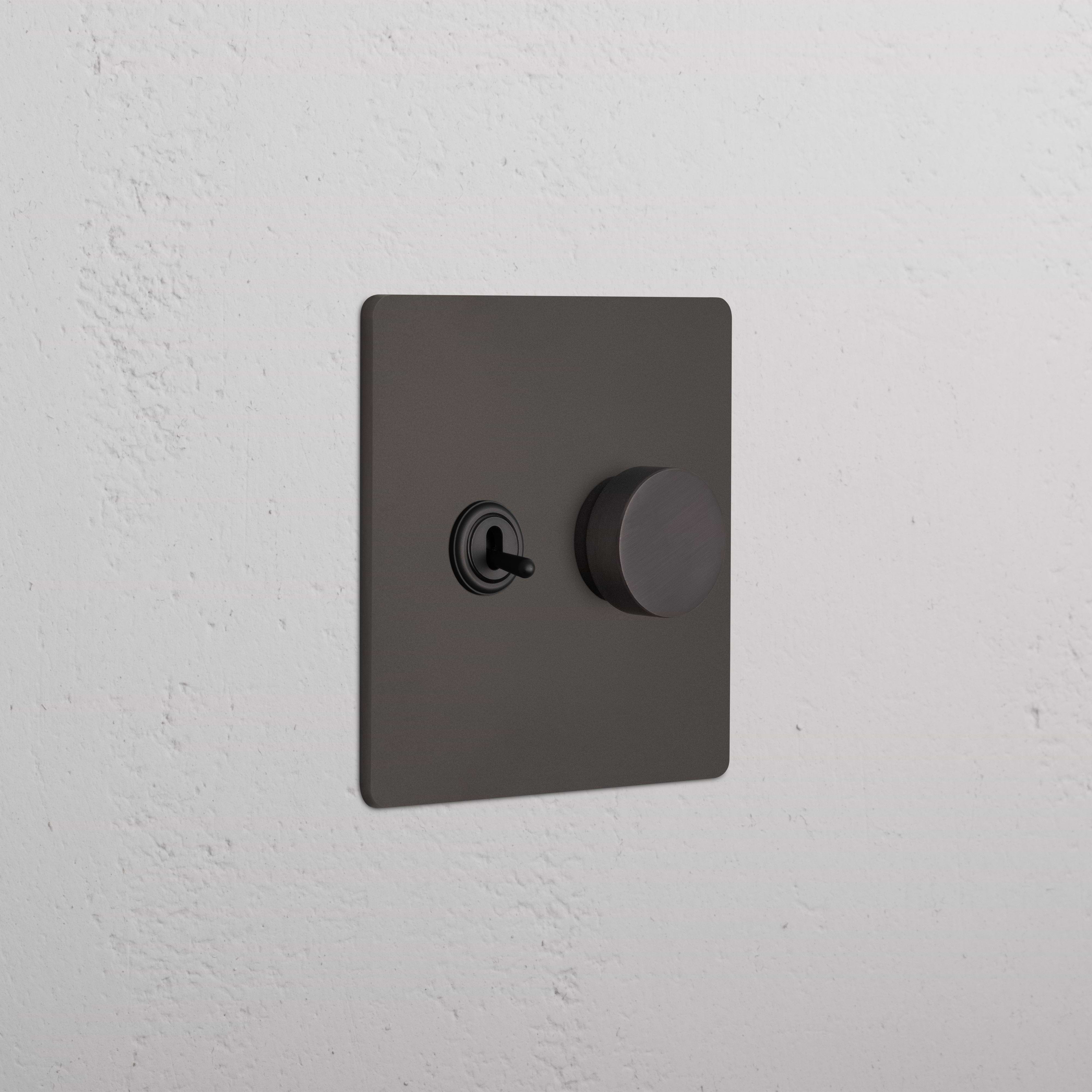 Grove 2G Toggle & Dimmer Switch in bronze finish, featuring a toggle switch and round dimmer knob.