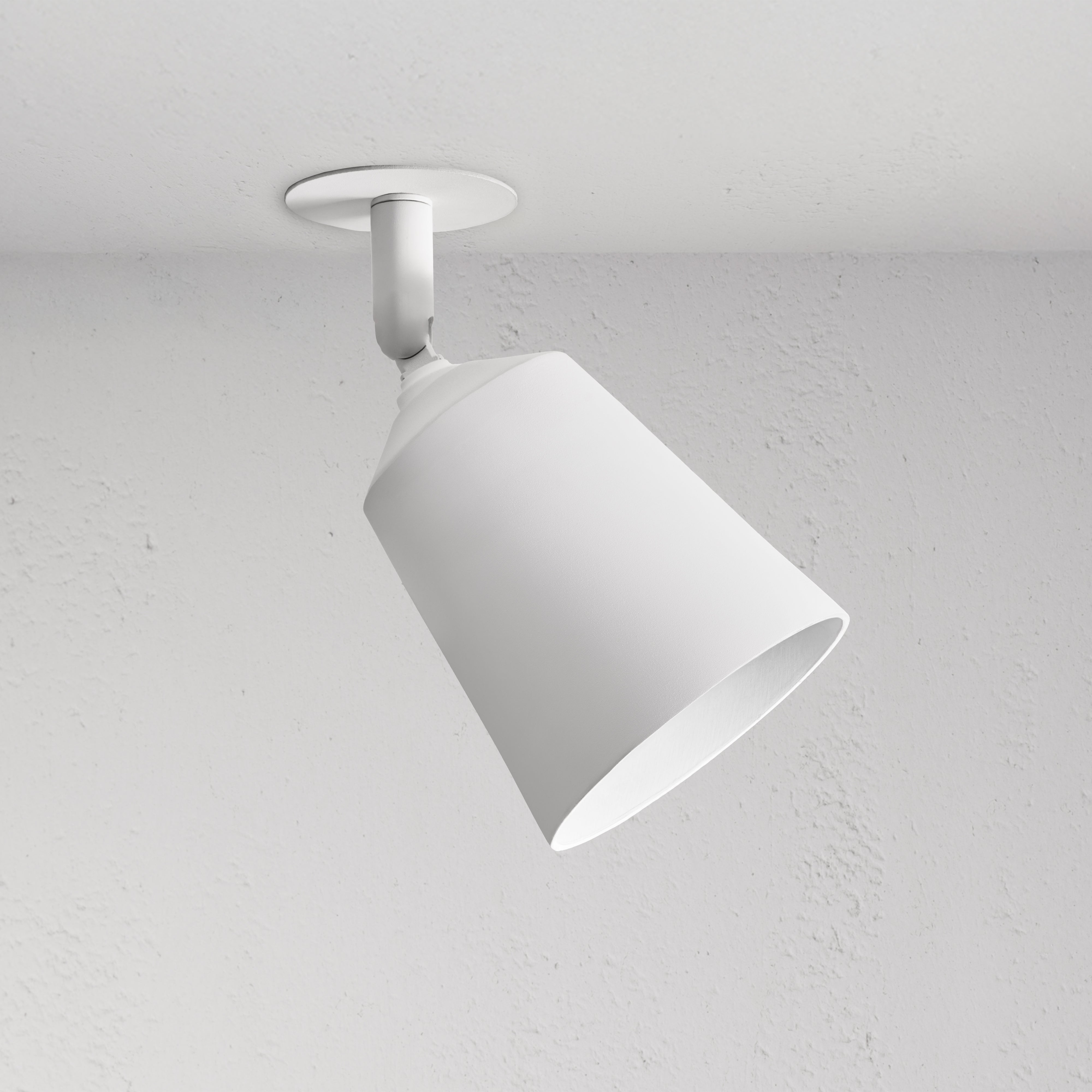 Pembroke Single 70mm Spotlight, white cone-shaped paintable ceiling light, angled downward on a ceiling.