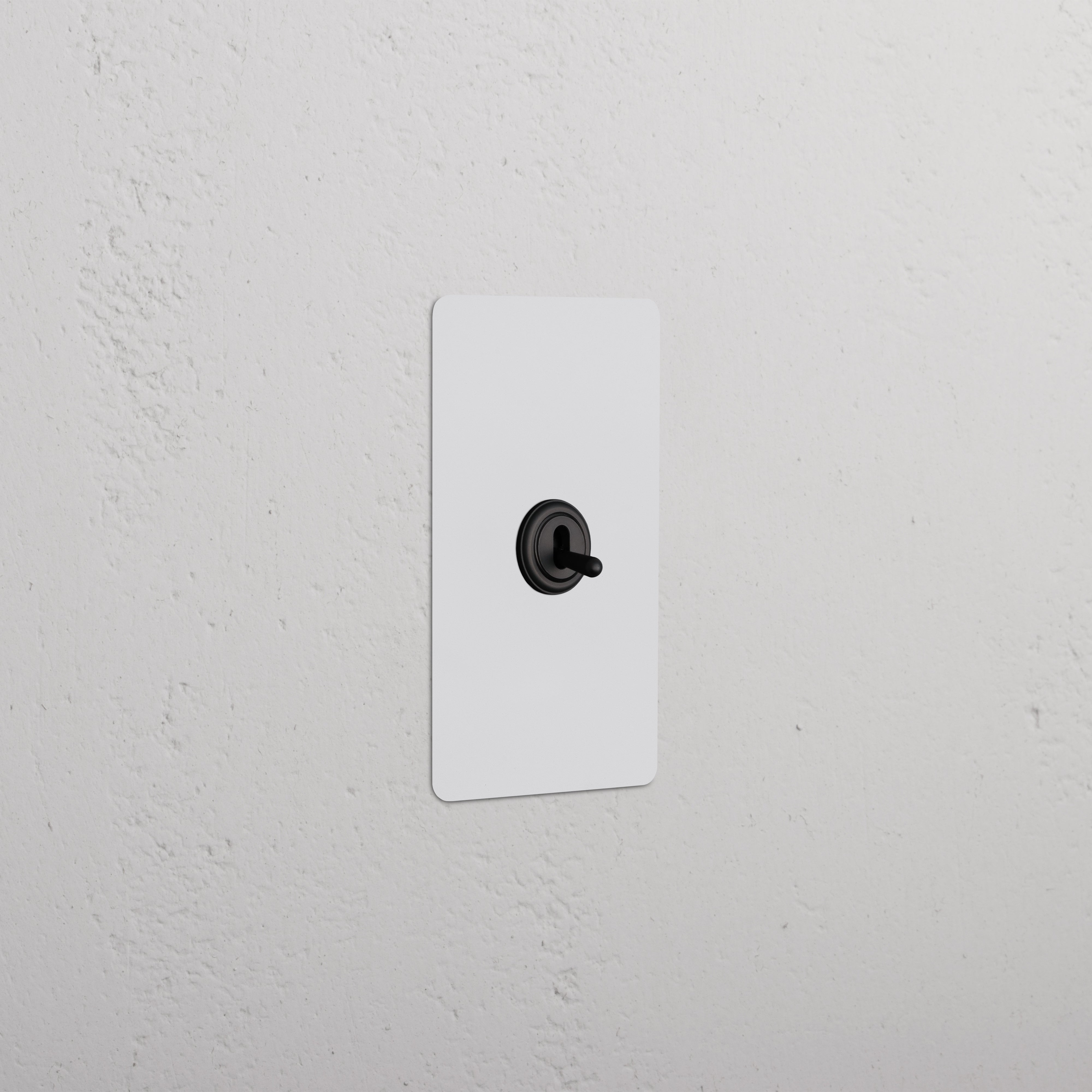 Kew 1G Retractive Toggle Switch in paintable bronze finish, single rectangular plate with a central black toggle.