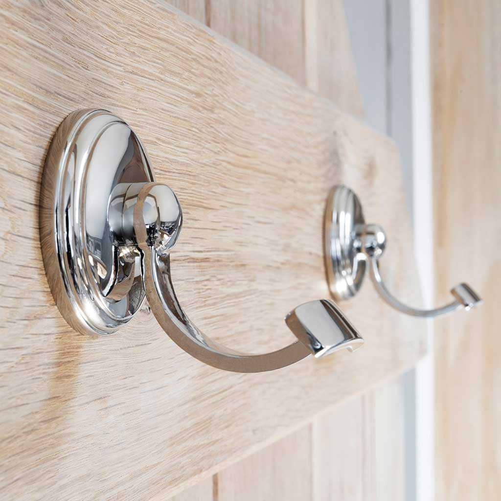 Portland Hook in polished nickel finish, mounted on a light wood board against a wall.