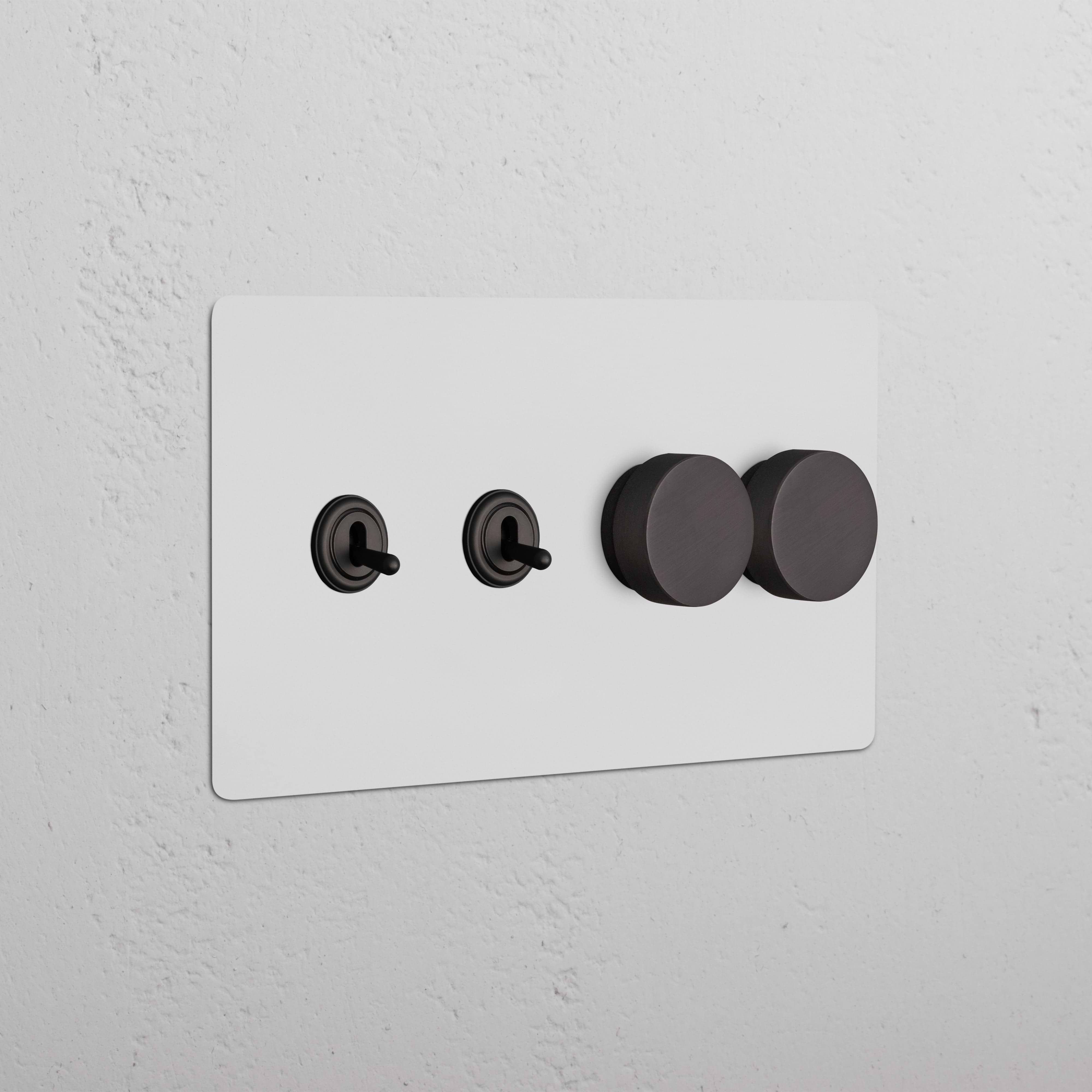 Kew 4G paintable bronze wall plate with two toggle switches and two dimmer knobs, shown on a white wall.