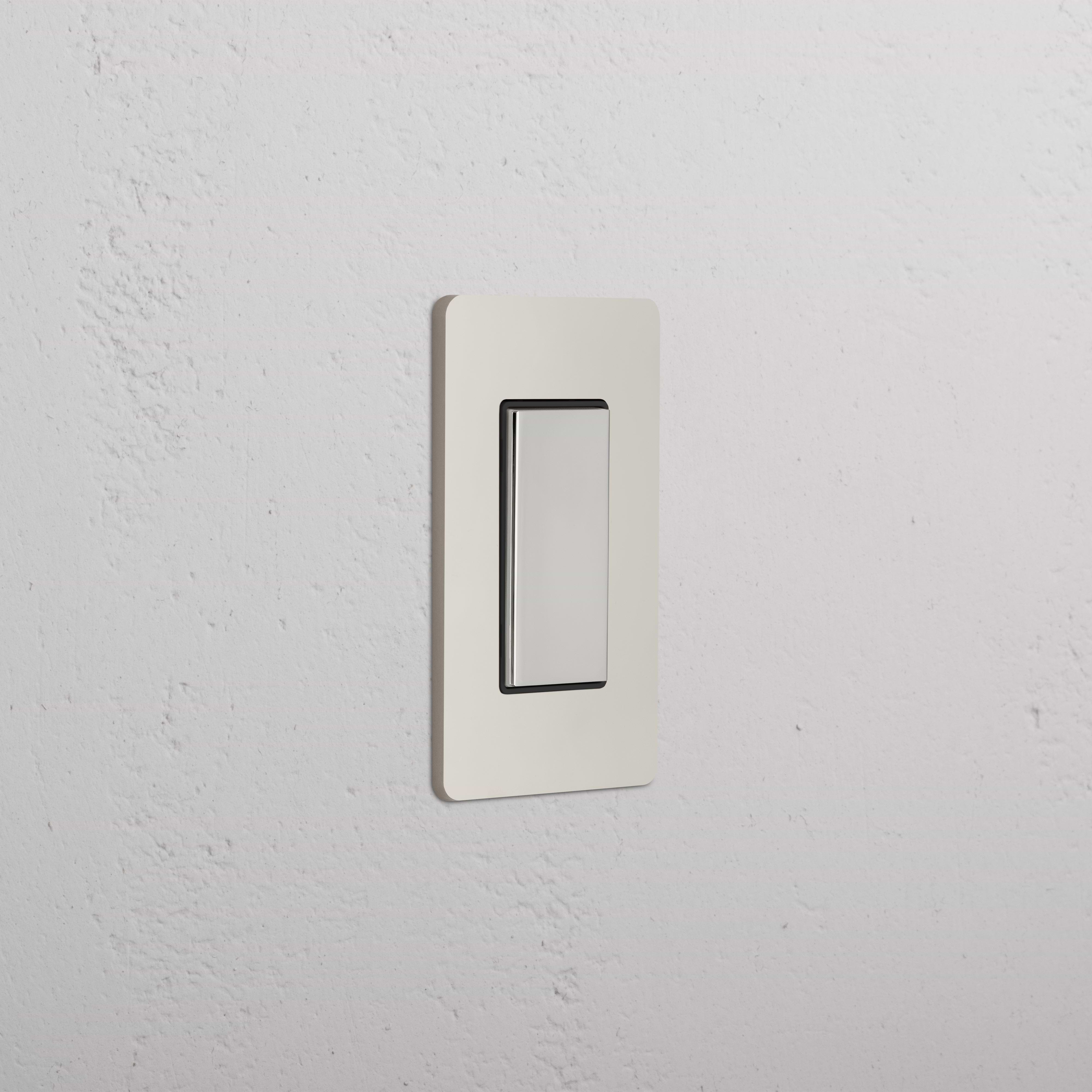 Grove 1G Center Retractive Rocker Switch in polished nickel black finish, mounted on a white textured wall.