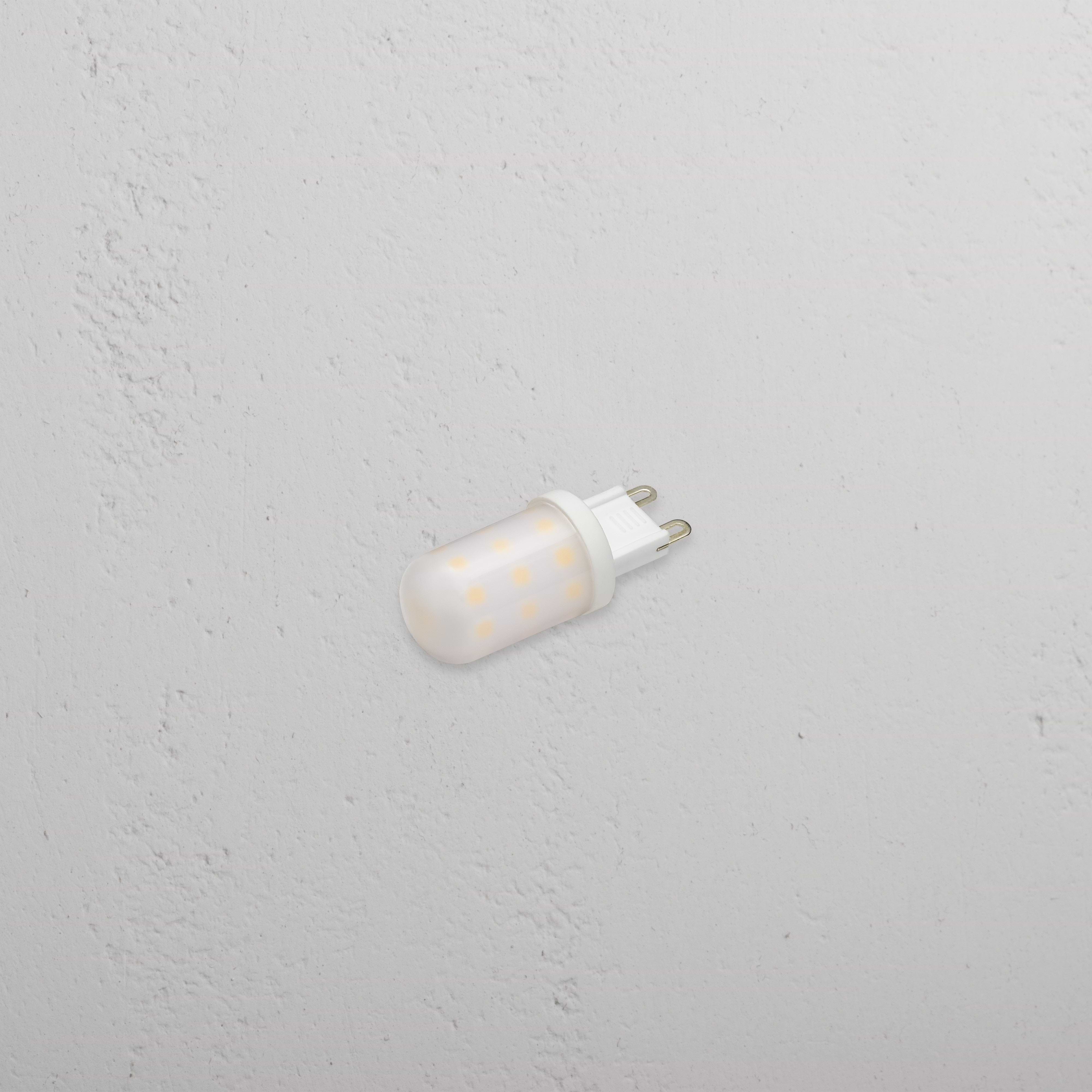 Eden 2.5W G9 LED Bulb with two metal prongs, designed for lighting, on a white textured surface.