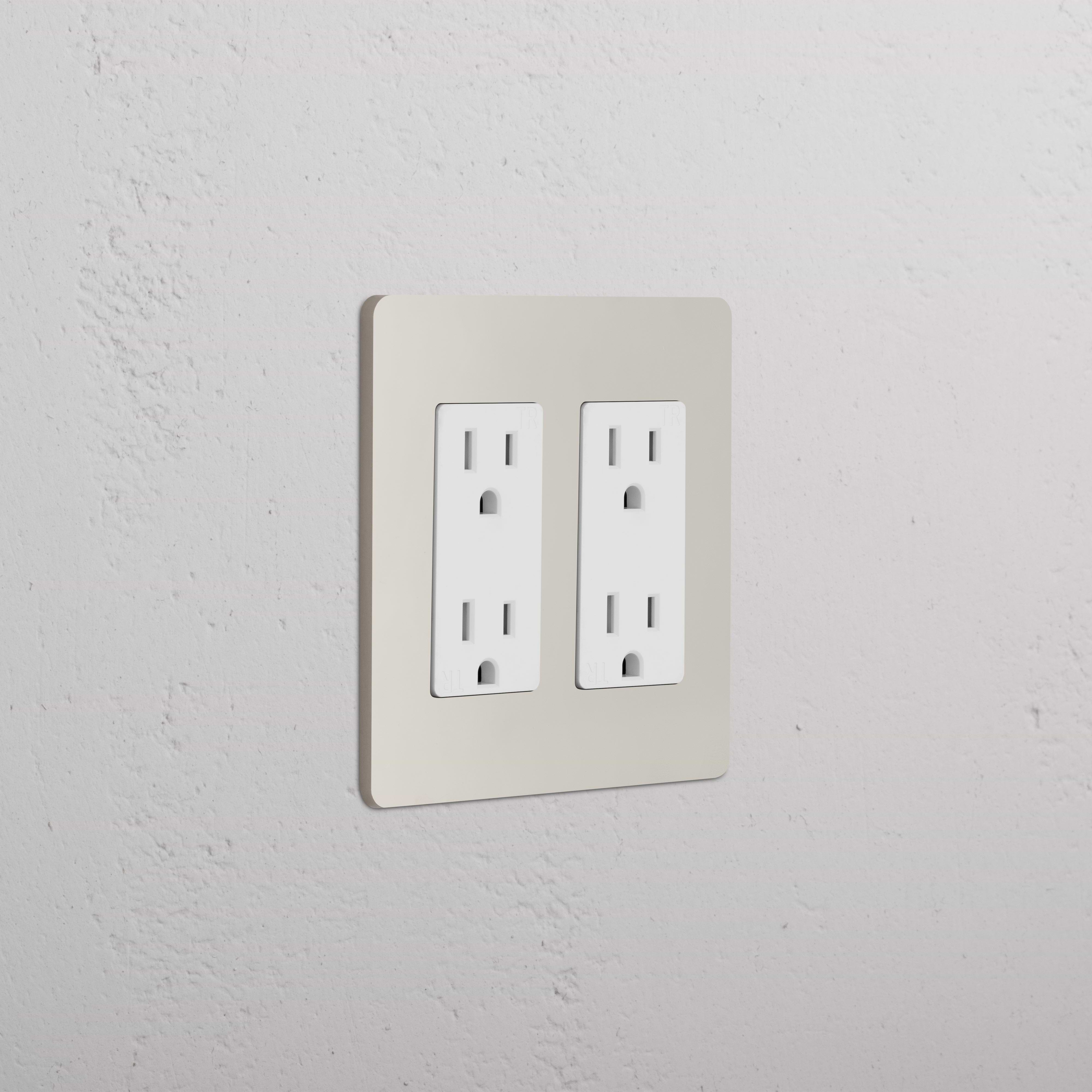 Grove 2G Outlet in polished nickel white finish, shown installed on a textured white wall.
