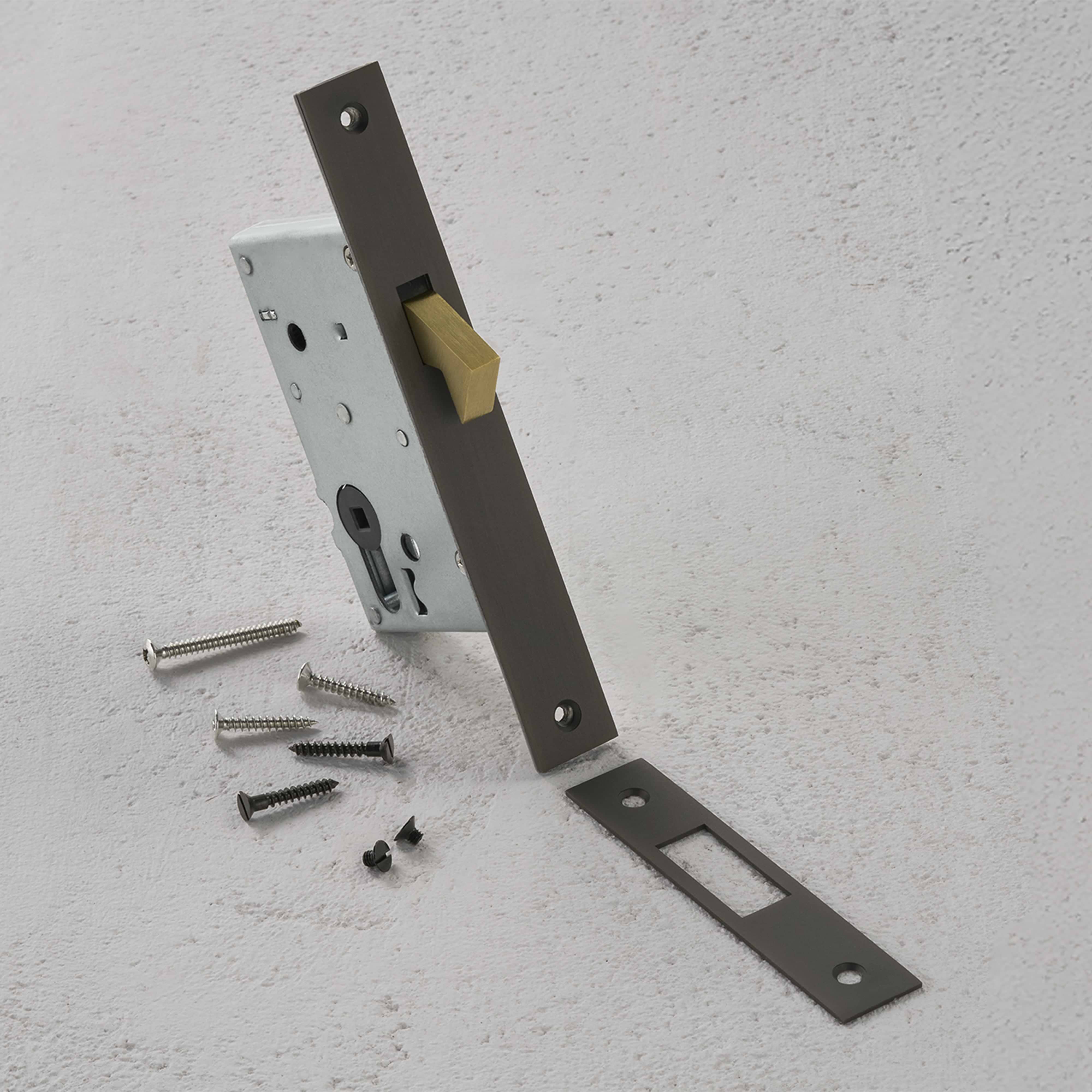 Bronze hook lock set with brushed faceplate, brass latch, strike plate, and screws on a white surface.