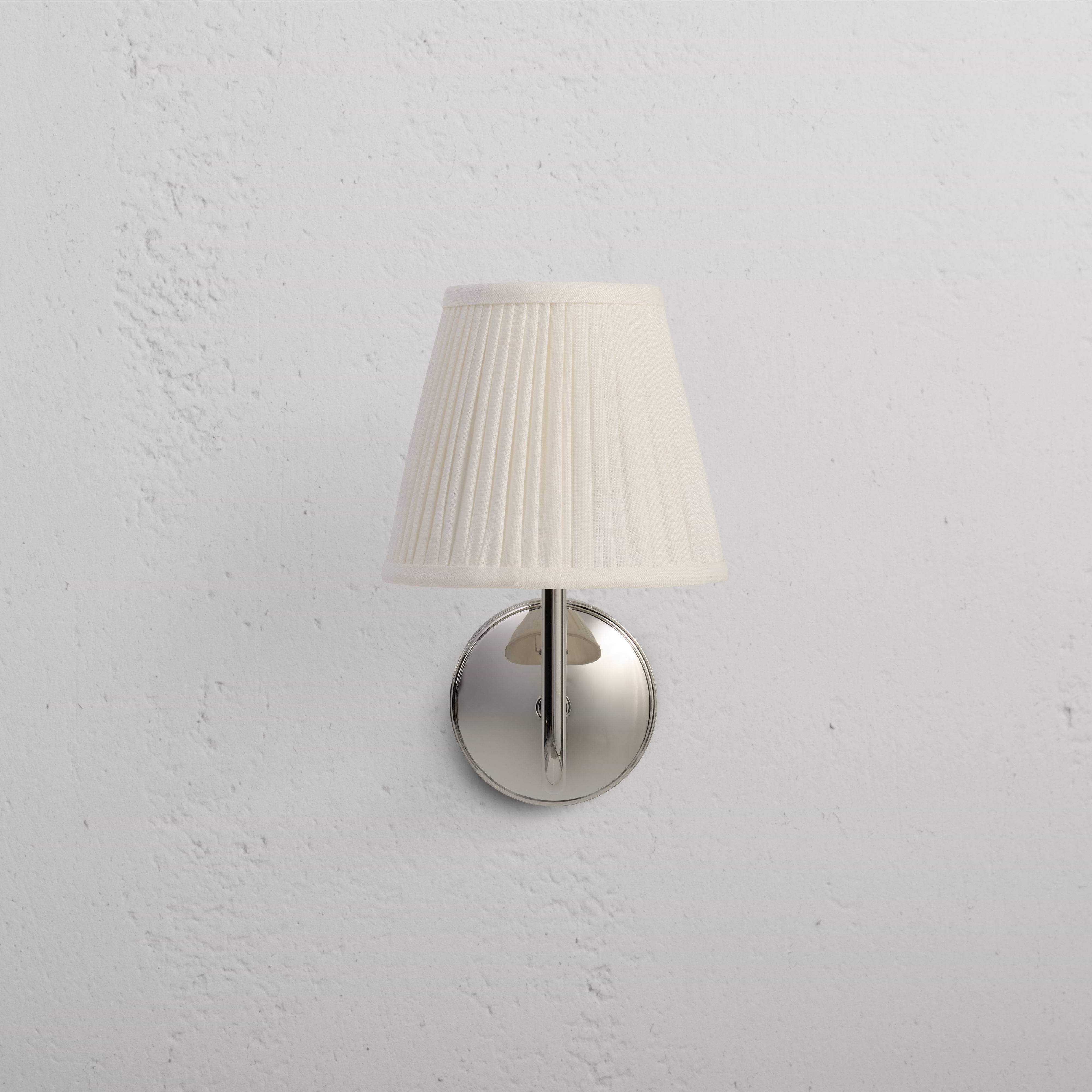 Malvern Medium Wall Light in Alabaster White with polished nickel base and pleated off-white lampshade.