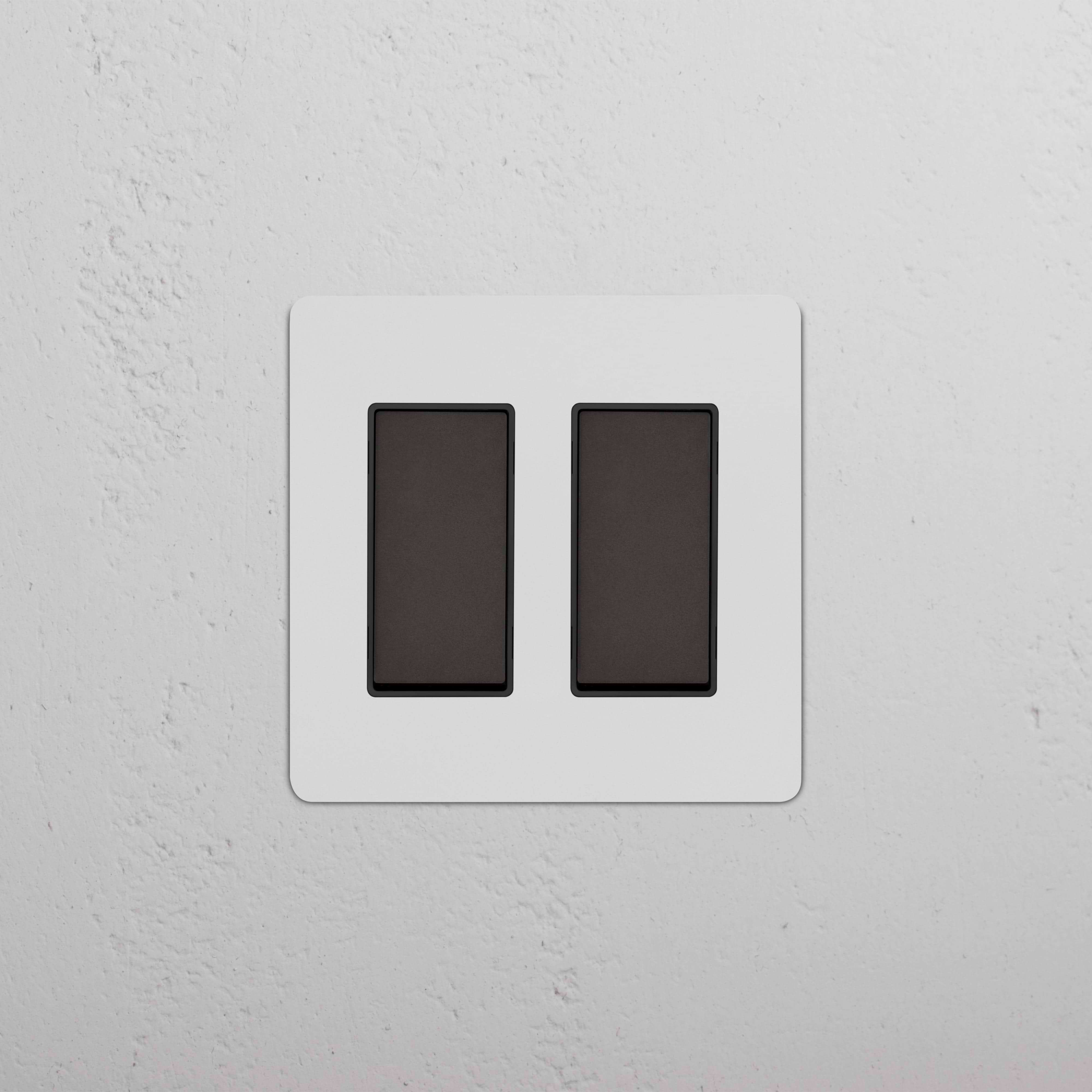 Kew 2G Rocker Switch in Paintable Bronze Black finish, showing two rocker switches on a wall plate.