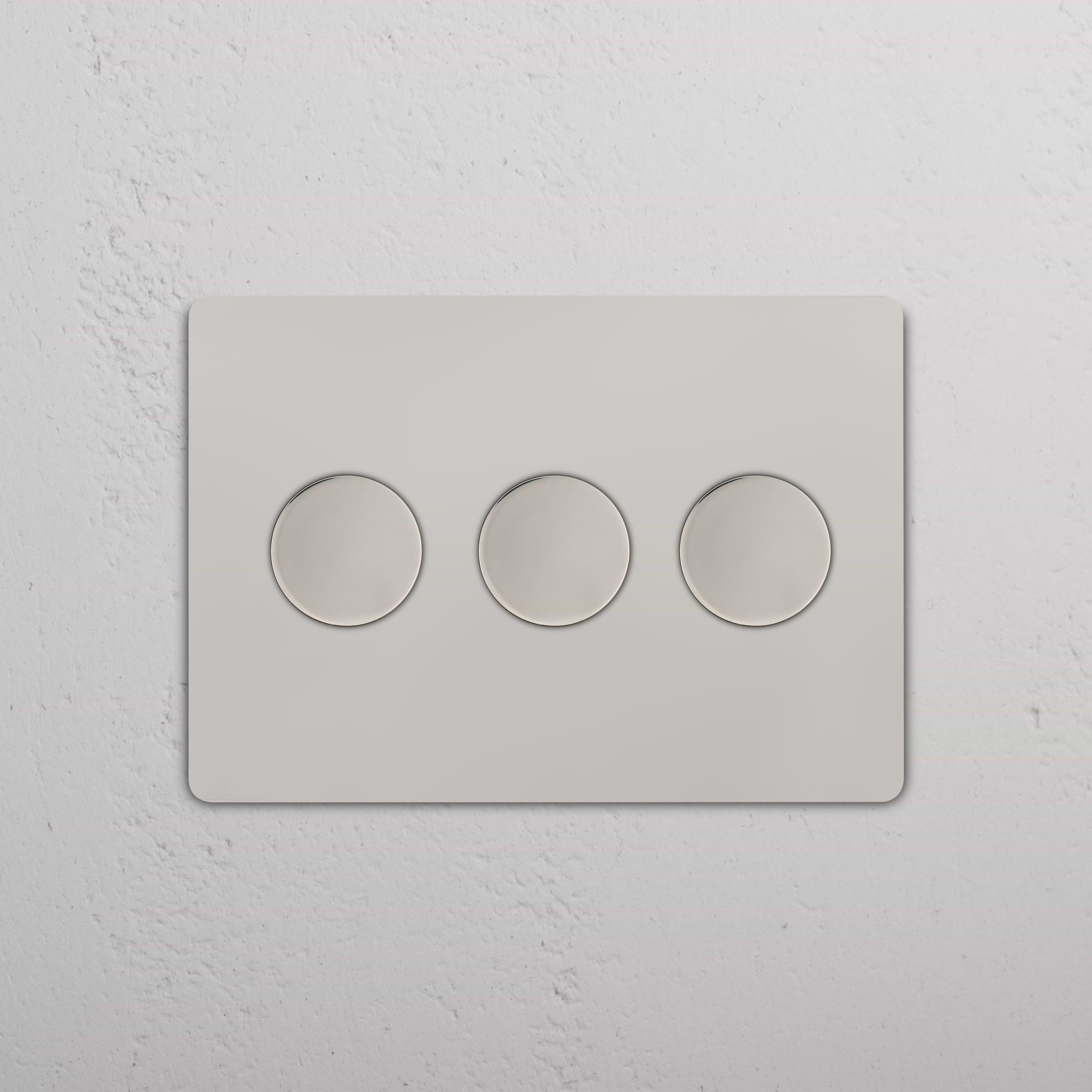 Grove 3G Dimmer Switch in polished nickel with three round push buttons on a white wall plate.