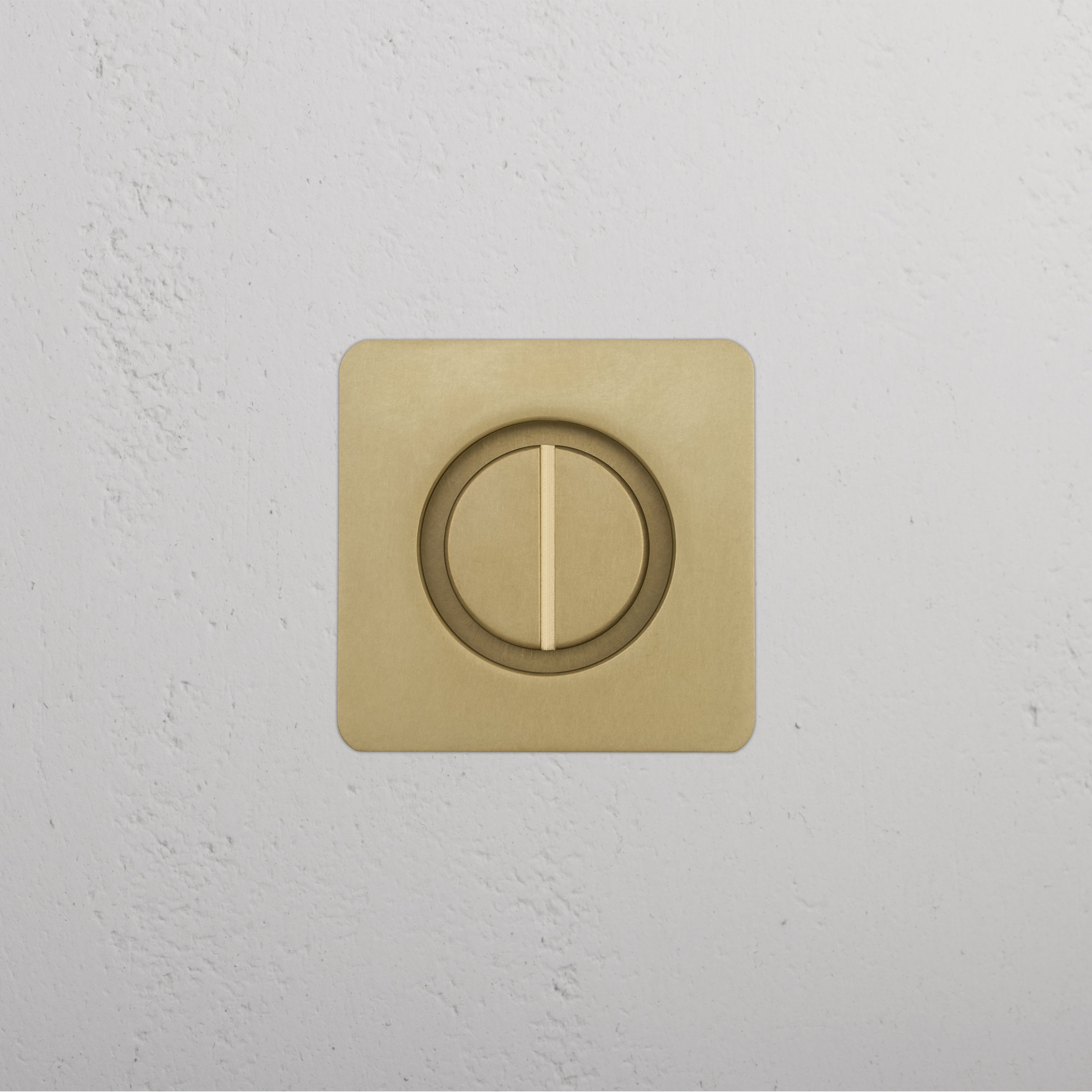 Regent Recessed Thumbturn in Antique Brass, showing a square plate with central thumbturn on white wall.