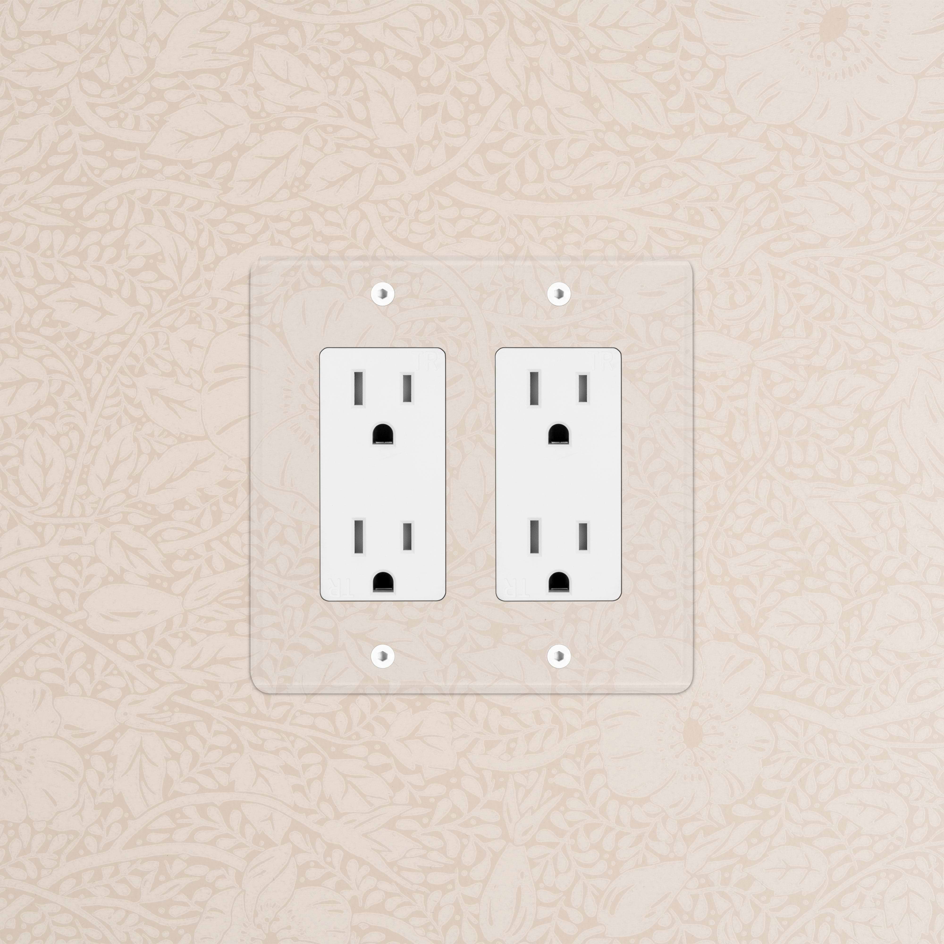 Kew 2G Outlet in Clear White finish featuring two sockets, mounted on a beige patterned wall.