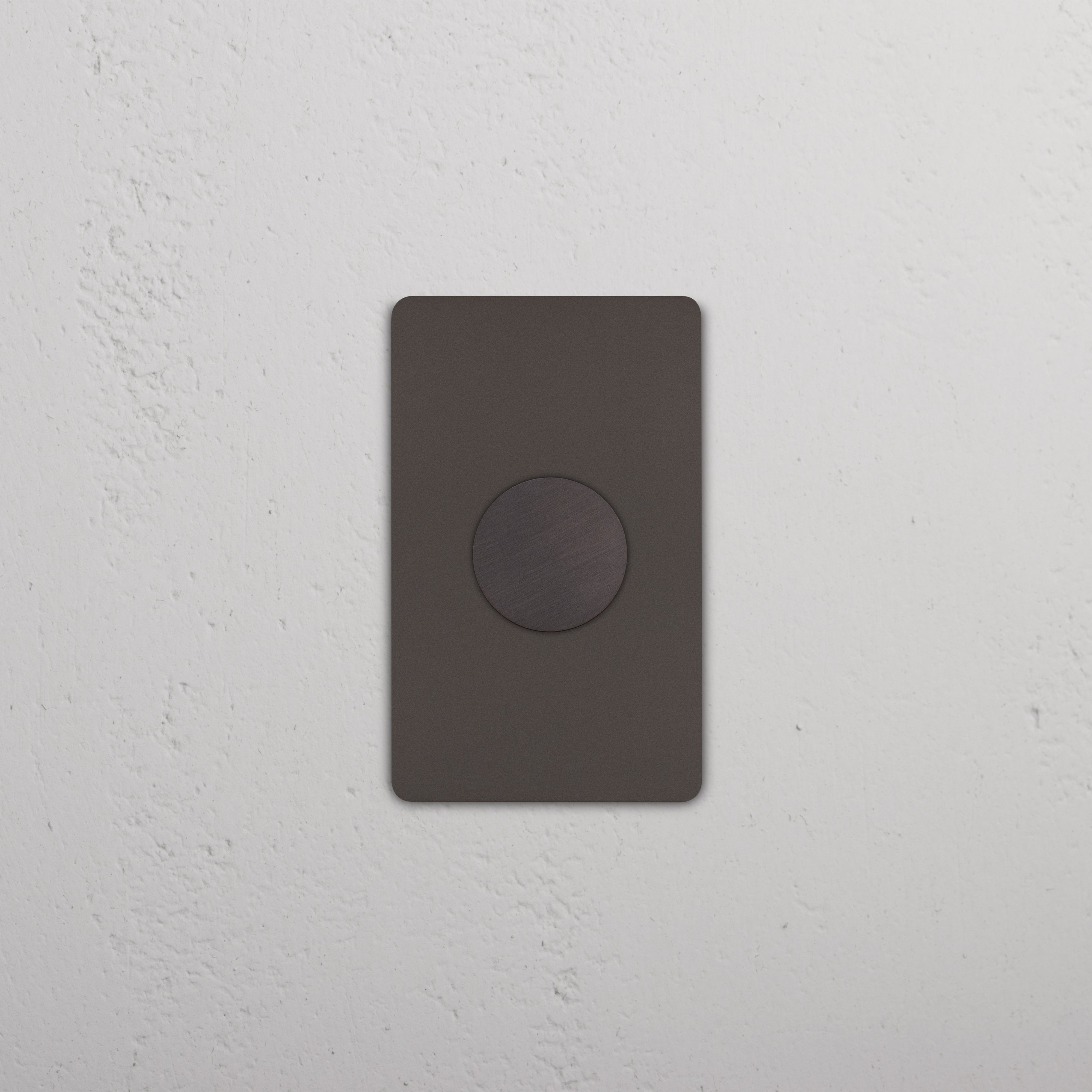 Grove 1G Dimmer Switch in bronze finish, featuring a circular control, installed on a white wall.
