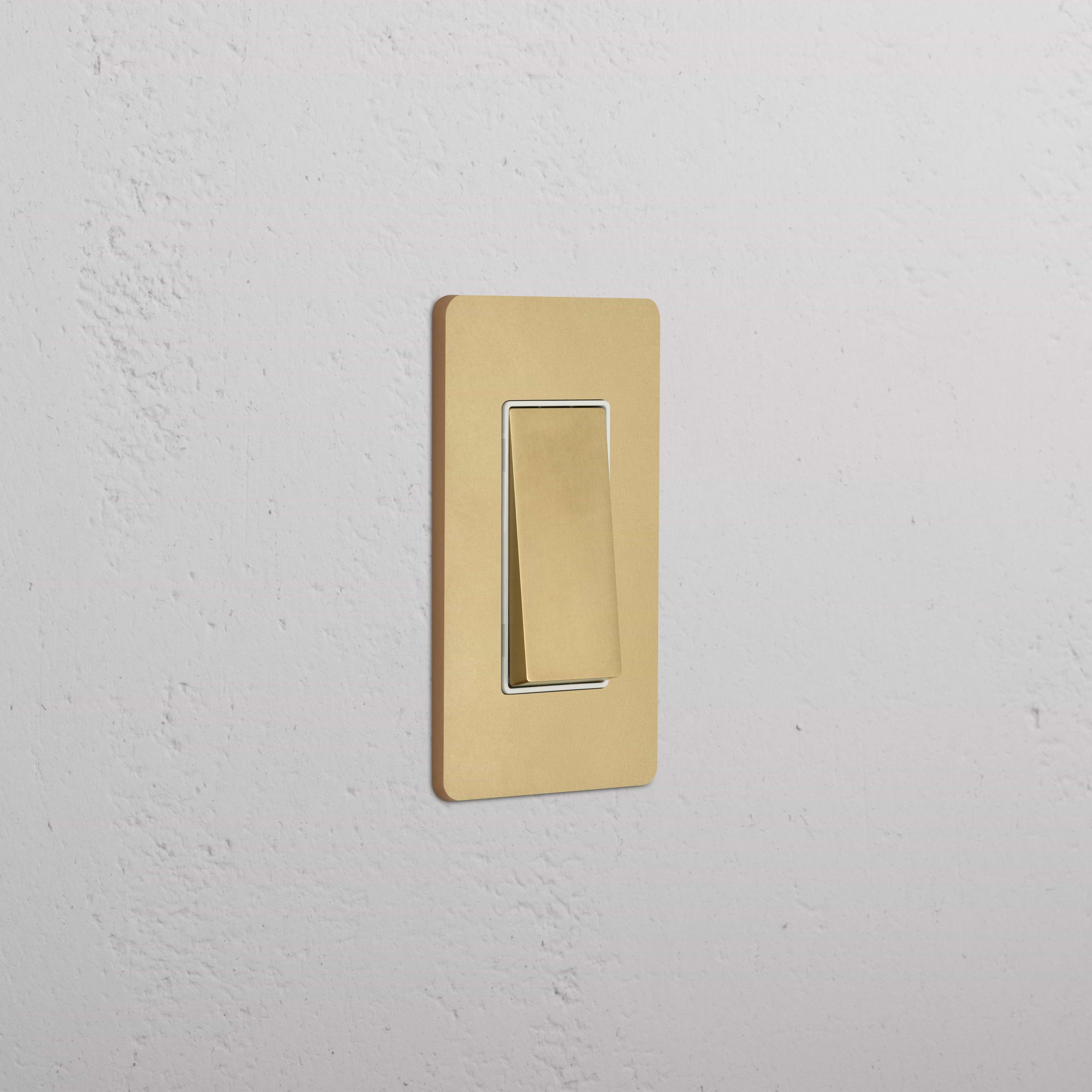 Grove 1G Double Pole Rocker Switch in Antique Brass White finish, shown mounted on a wall.